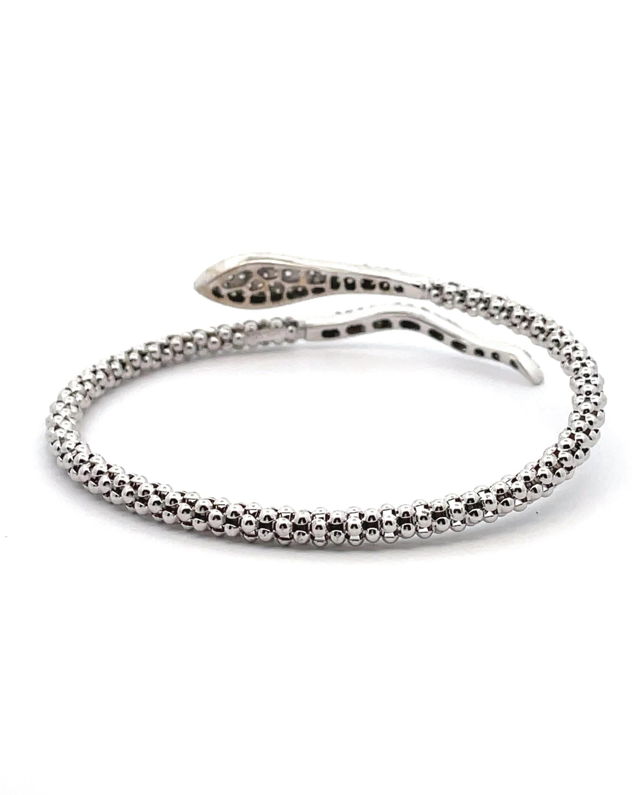 14K white gold snake wrap bracelet with 110 round brilliant-cut pavee set diamonds weighing 0.90 carats total.

* Diamonds are G/H color, SI clarity
* Bracelet is semi flexible