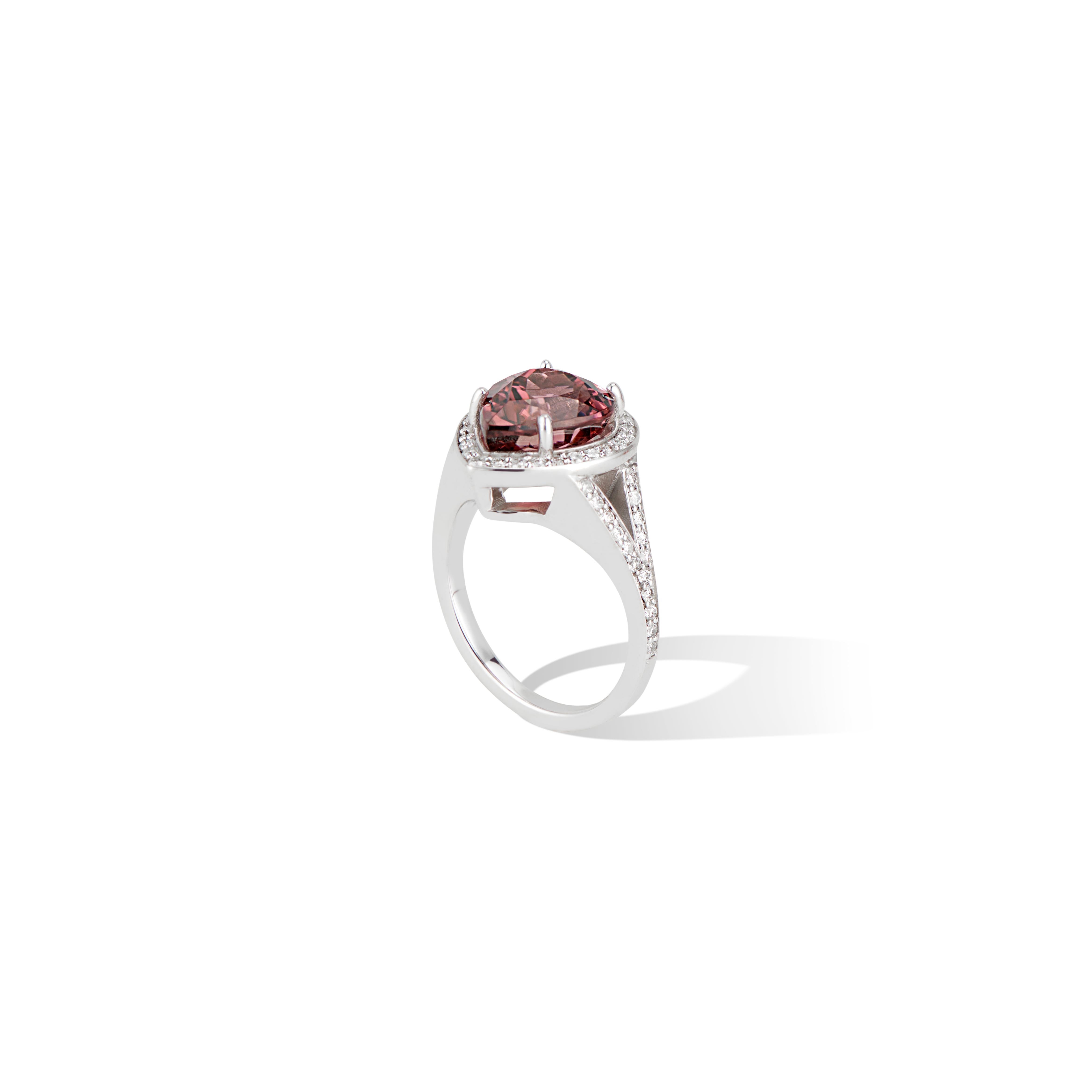 A stunning split shank style ring, with a scintillating halo of brilliant diamonds surrounding a striking pink pear tourmaline center and continuous sparkling pave set band.

A large 4.43 carat tourmaline and very unique shade of pink creates this