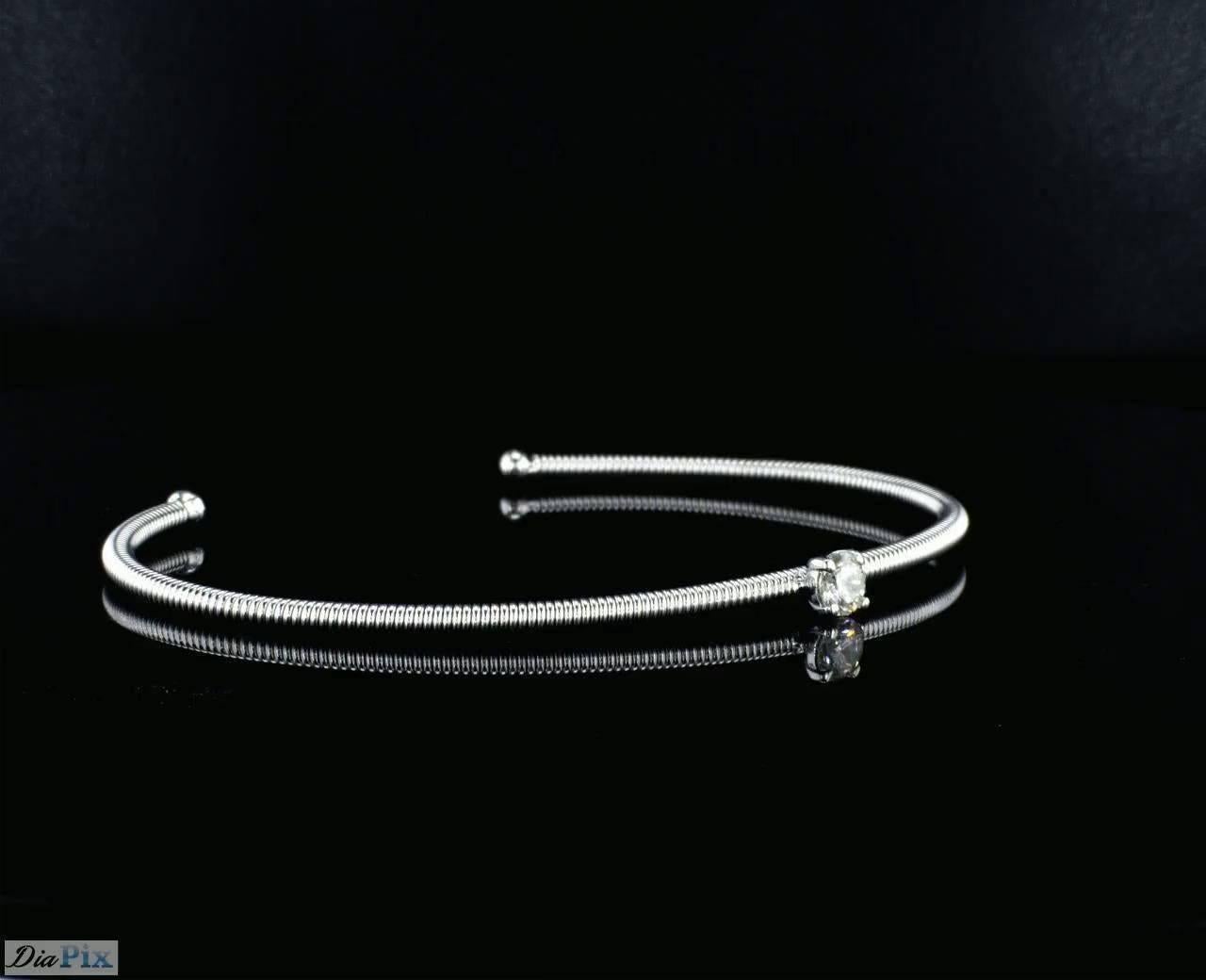 Contemporary 14K White Gold Spring Bangle Bracelet with a Center Diamond For Sale