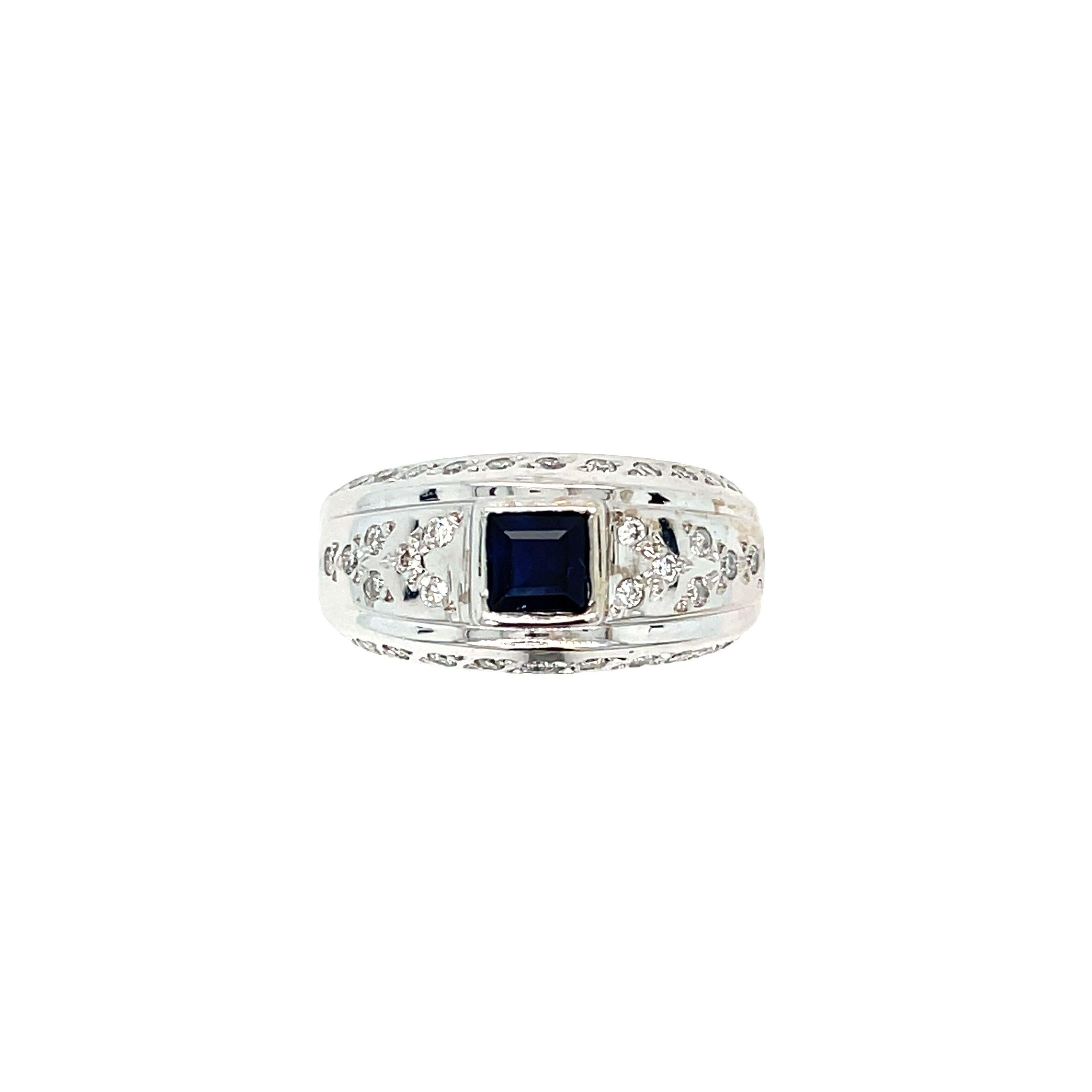 Elegant and contemporary, this 14K White Gold Sapphire Diamond Ring features a stunning square-shaped Sapphire weighing approximately 0.65 carat. Center Sapphire is beautifully showcased in a raised bezel setting, complemented by a dome setting