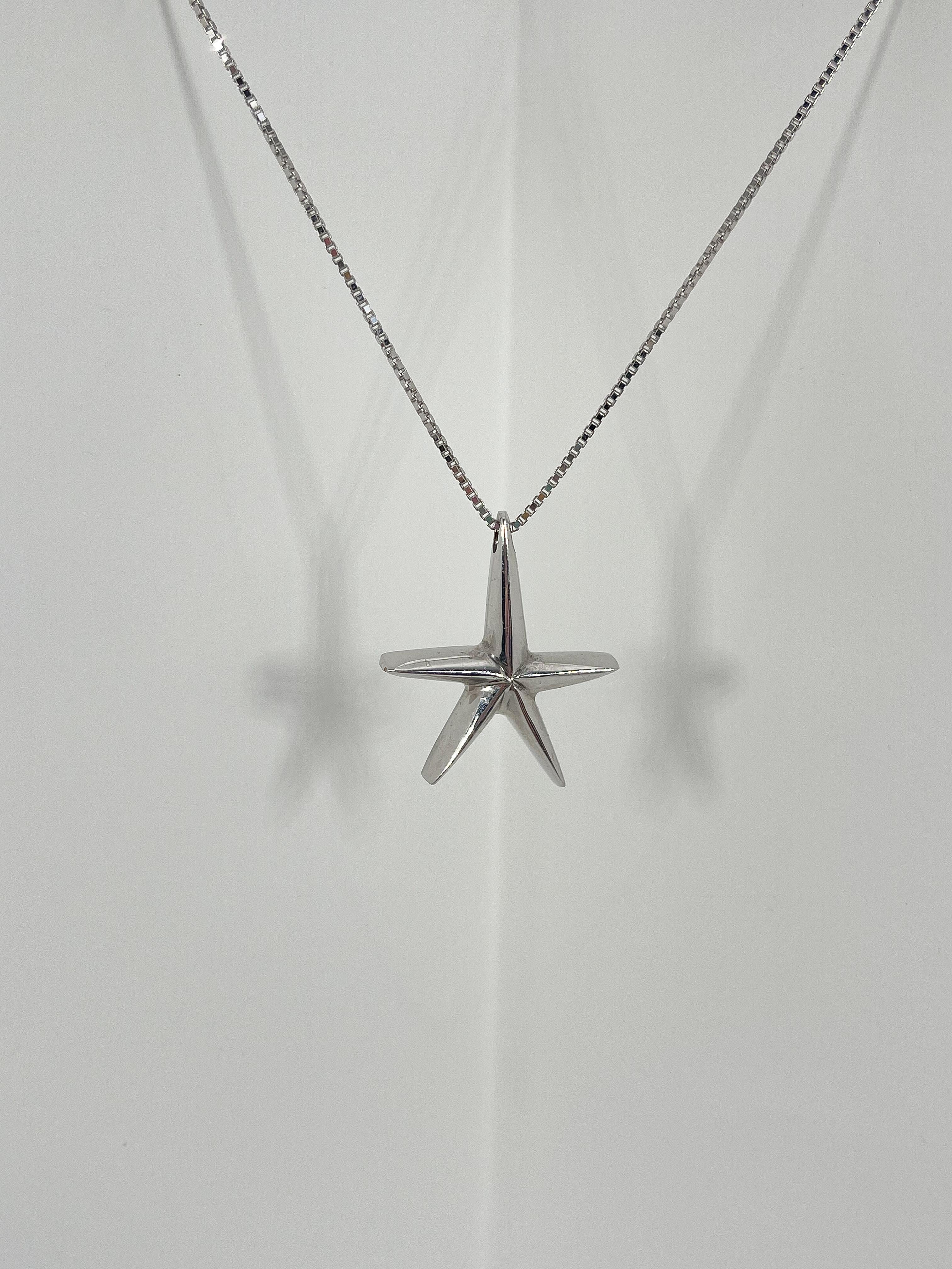 14k white gold starfish pendant necklace. The pendant comes on an 18 inch box chain, the pendant measures to be 27.5mm x 24mm, has a lobster clasp to open and close, and has a total weight of 5.3 grams.