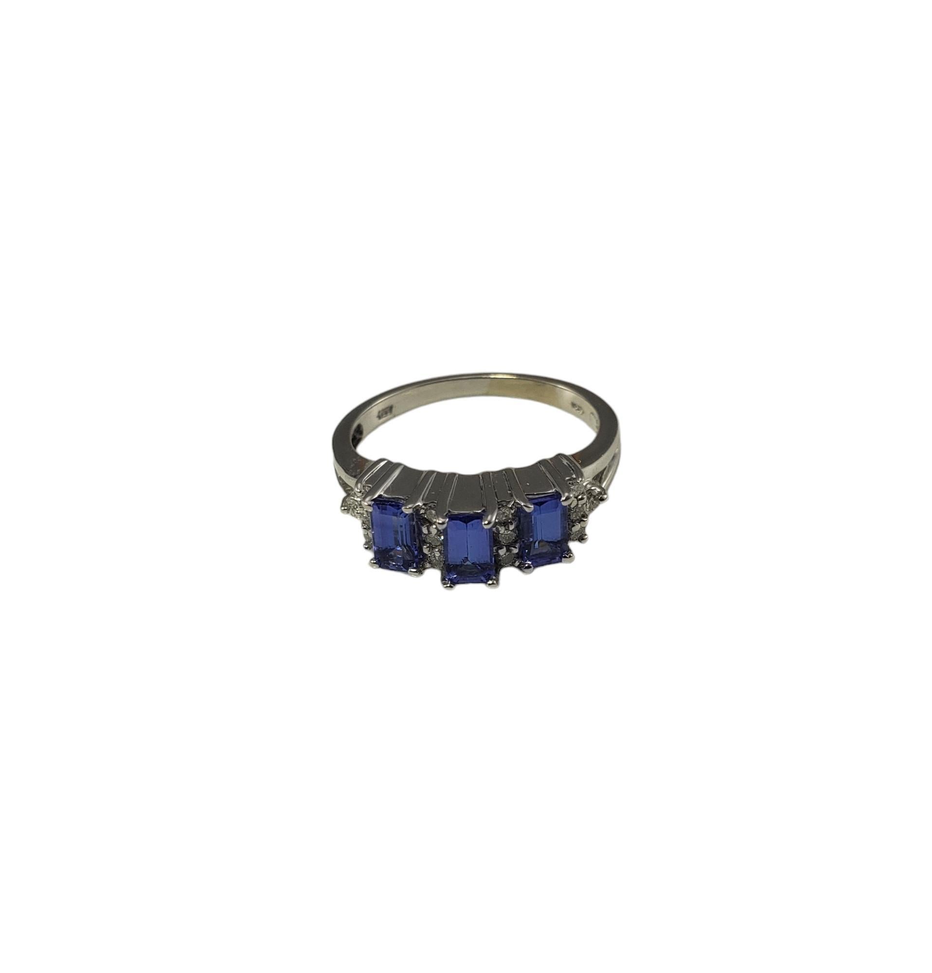 Vintage 14K White Gold Tanzanite and Diamond Ring Size 7 Certified-

This stunning ring features three emerald cut tanzanites (5 mm x 3 mm) and 14 round brilliant cut diamonds set in classic 14K white gold.  Width: 6 mm.  Shank: 2 mm.

Total