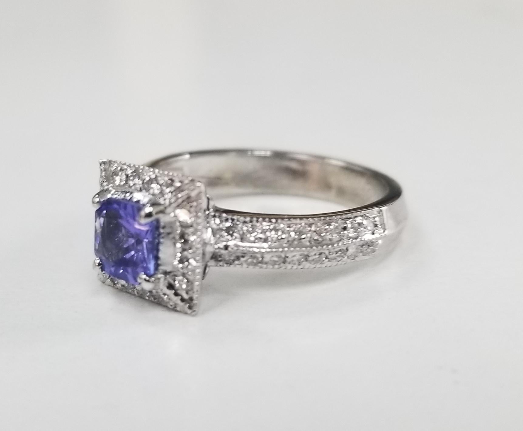 14k white gold tanzanite and diamond ring with halo, containing 1 square cut tanzanite weighing .75pts. and 48 round full cut diamonds of very fine quality weighing 1.05cts. ring is a size 5.75 and can be sized to fit for free.