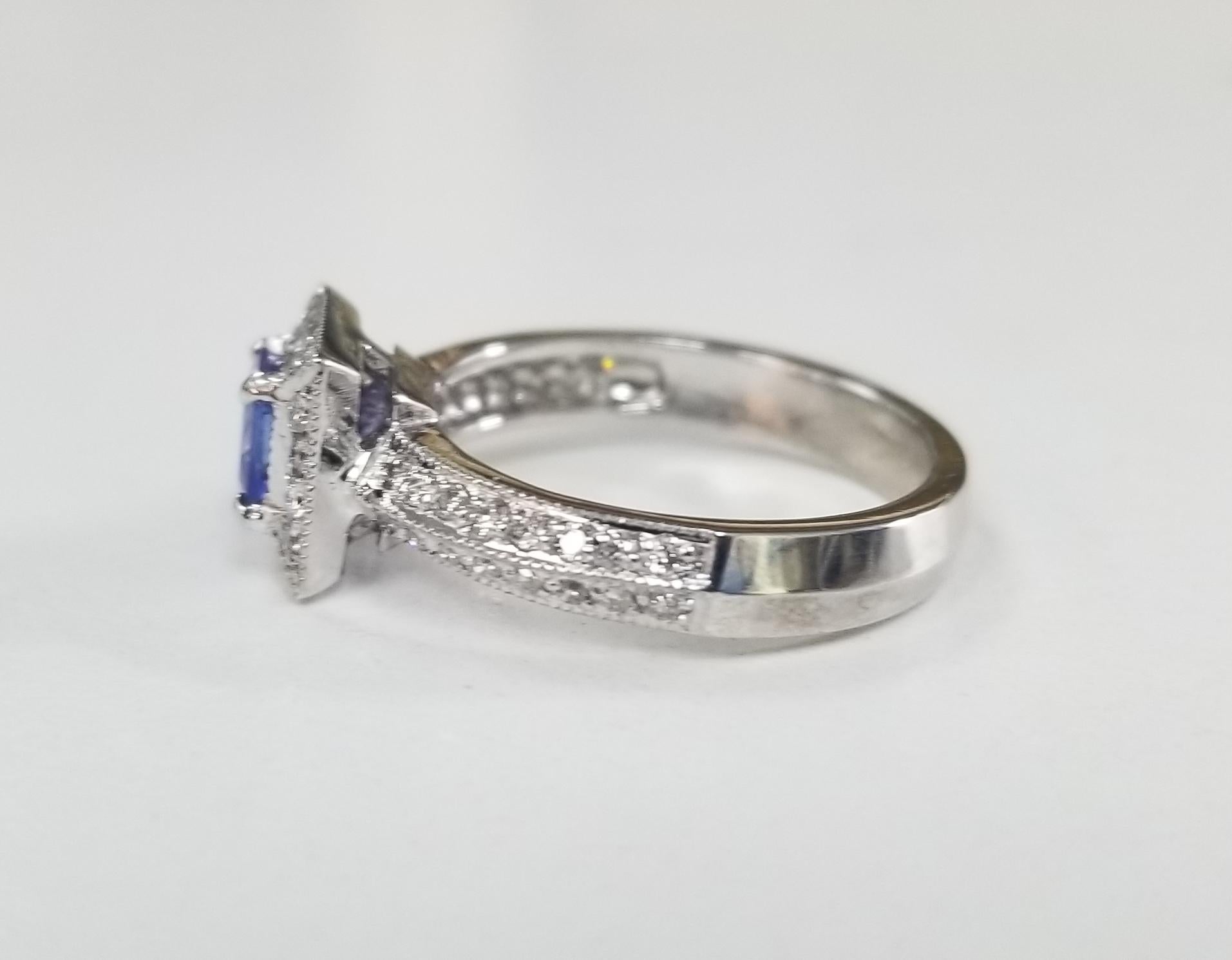 Contemporary 14 Karat White Gold Tanzanite and Diamond Ring with Halo For Sale