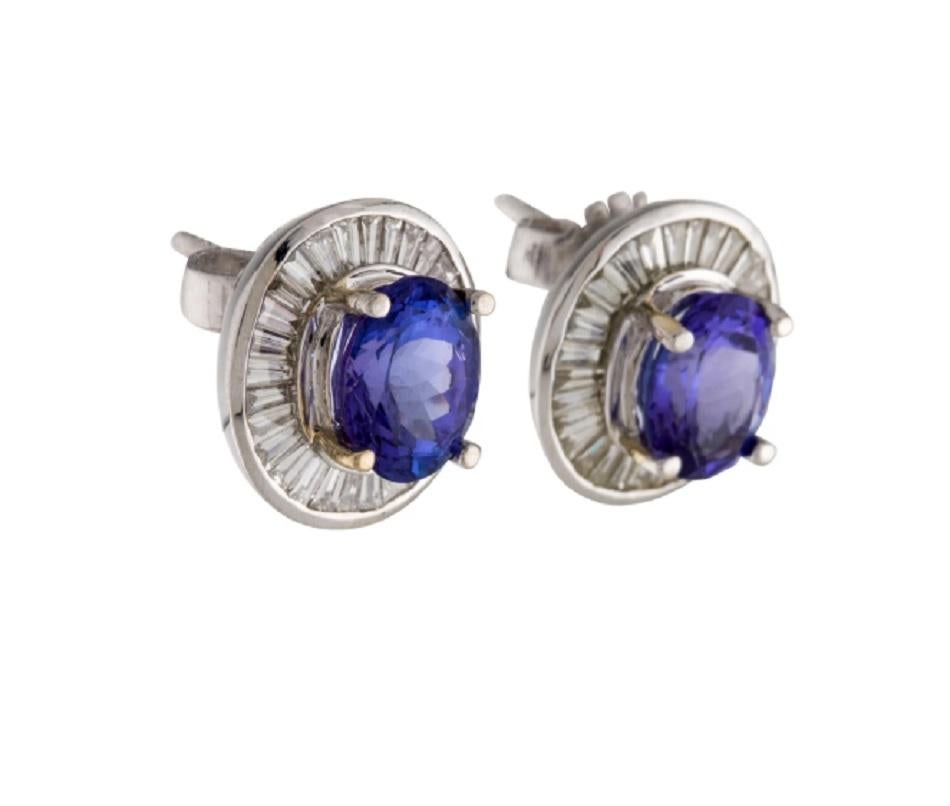 This is a breath-taking tanzanite and diamond stud earrings stamped in 18K white gold. The striking tanzanite has a rich color and is encompassed by delicate white diamonds.

*****
Details:
►Metal: White Gold
►Gold Purity 18K
►Natural White