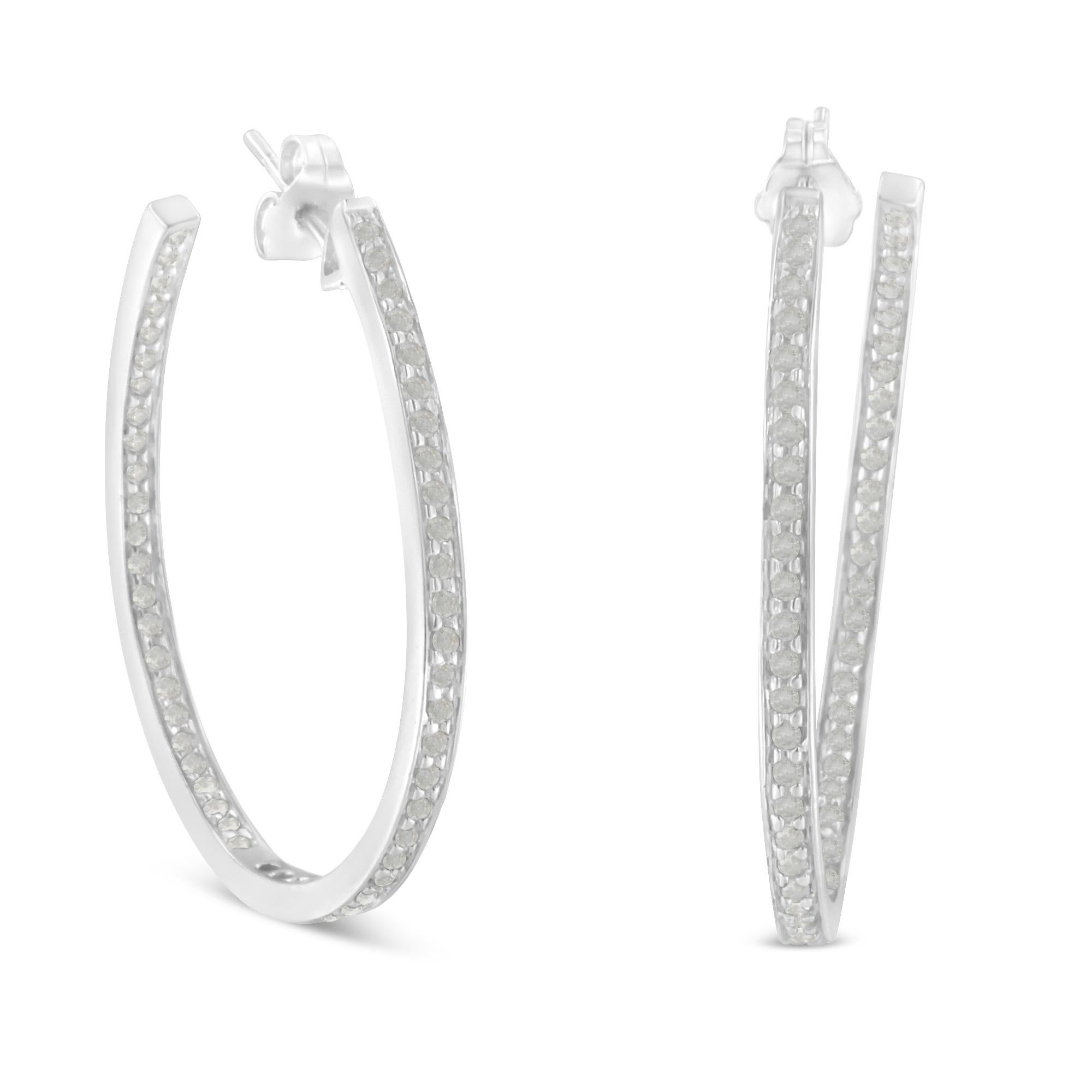 Be glamorous every day with these polished 14k white gold and diamond hoop earrings.  Set with round diamonds on both the front and back ledges, these earrings are sure to sing.  Hinged ear wires make them easy to wear and secure.  Treat yourself to