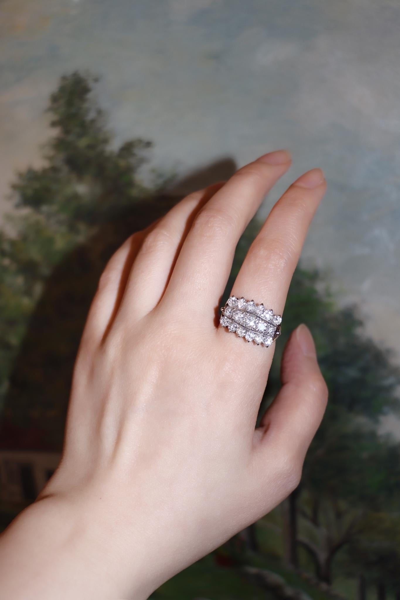 14K White Gold Three Row Diamond Princess Ring

Approximate Dimensions:
7.5 - 7.75 (Ring Size)
2.20 carats (Diamond)
6.2 grams in weights.