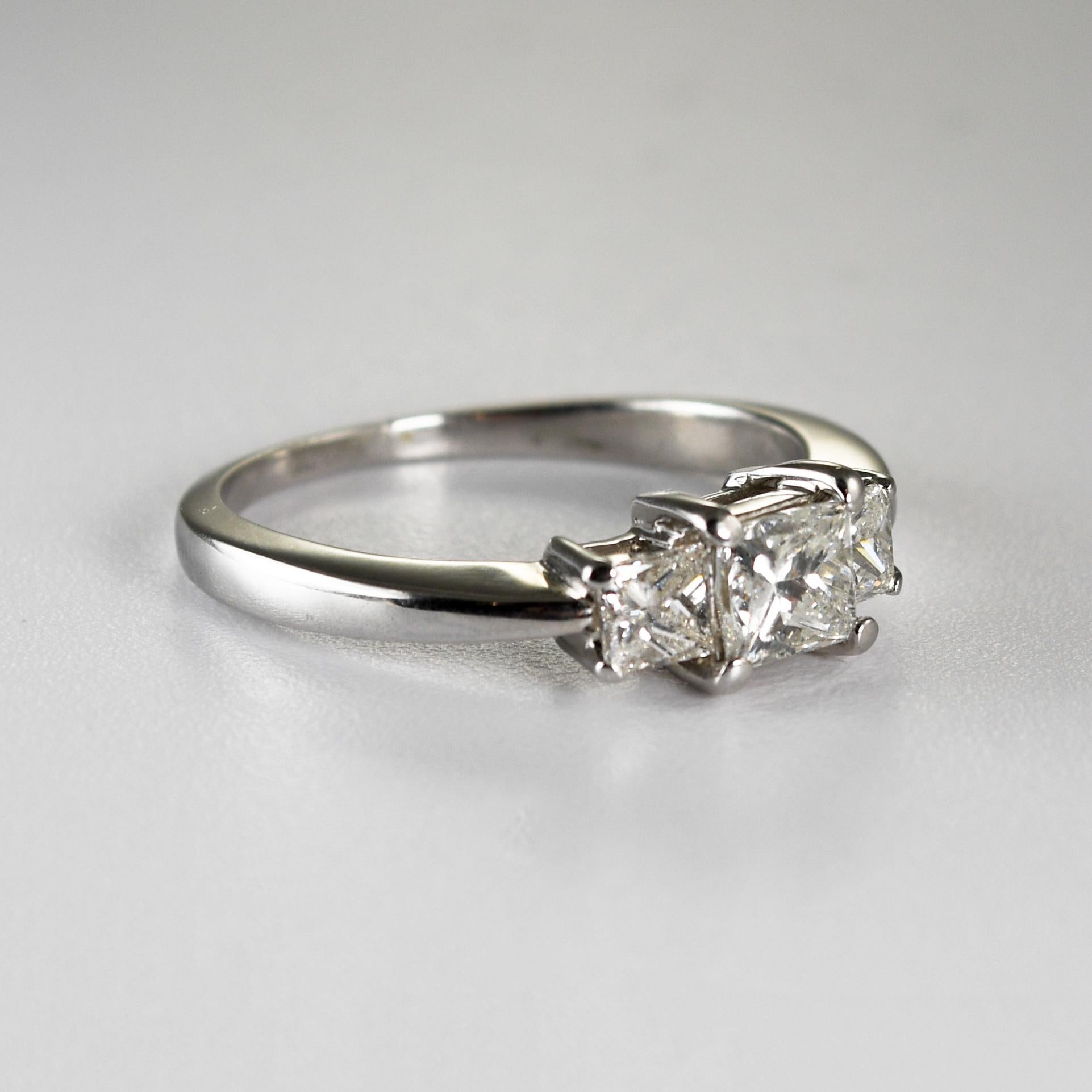 Ladies' three diamond ring in 14k white gold with 1.15 tdw
Stamped 14k and weighs 4 grams.
The center diamond is a princess cut, 5mm by 4.5mm, .70 carats, G,H,i  color, SI clarity, good cut.
The two side diamonds are princess cuts .45 total carats,