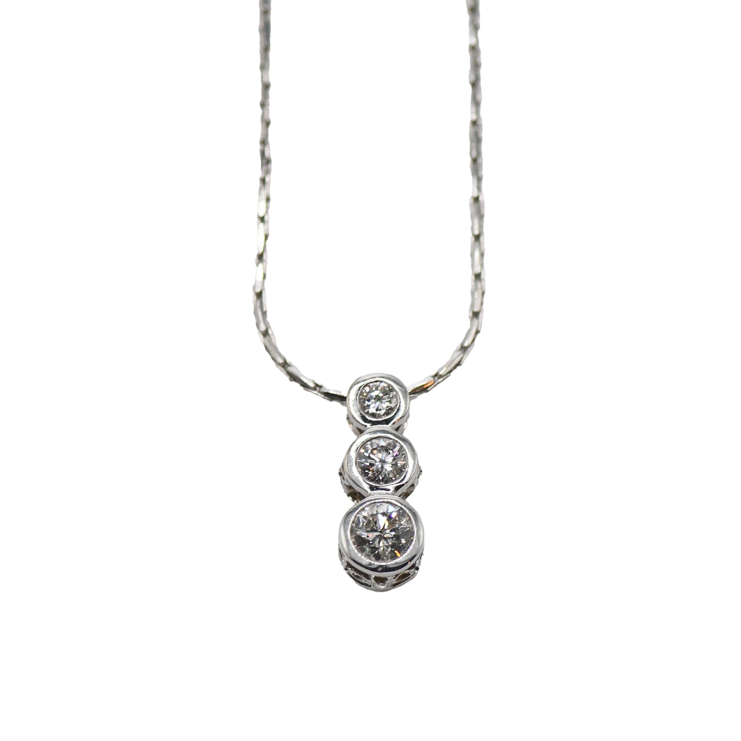 14K White Gold Three Stone Diamond Necklace

Elevate your elegance with a 14k white gold three-stone diamond pendant necklace, a masterpiece of timeless beauty and sophistication. This remarkable piece is a symbol of enduring love, featuring three