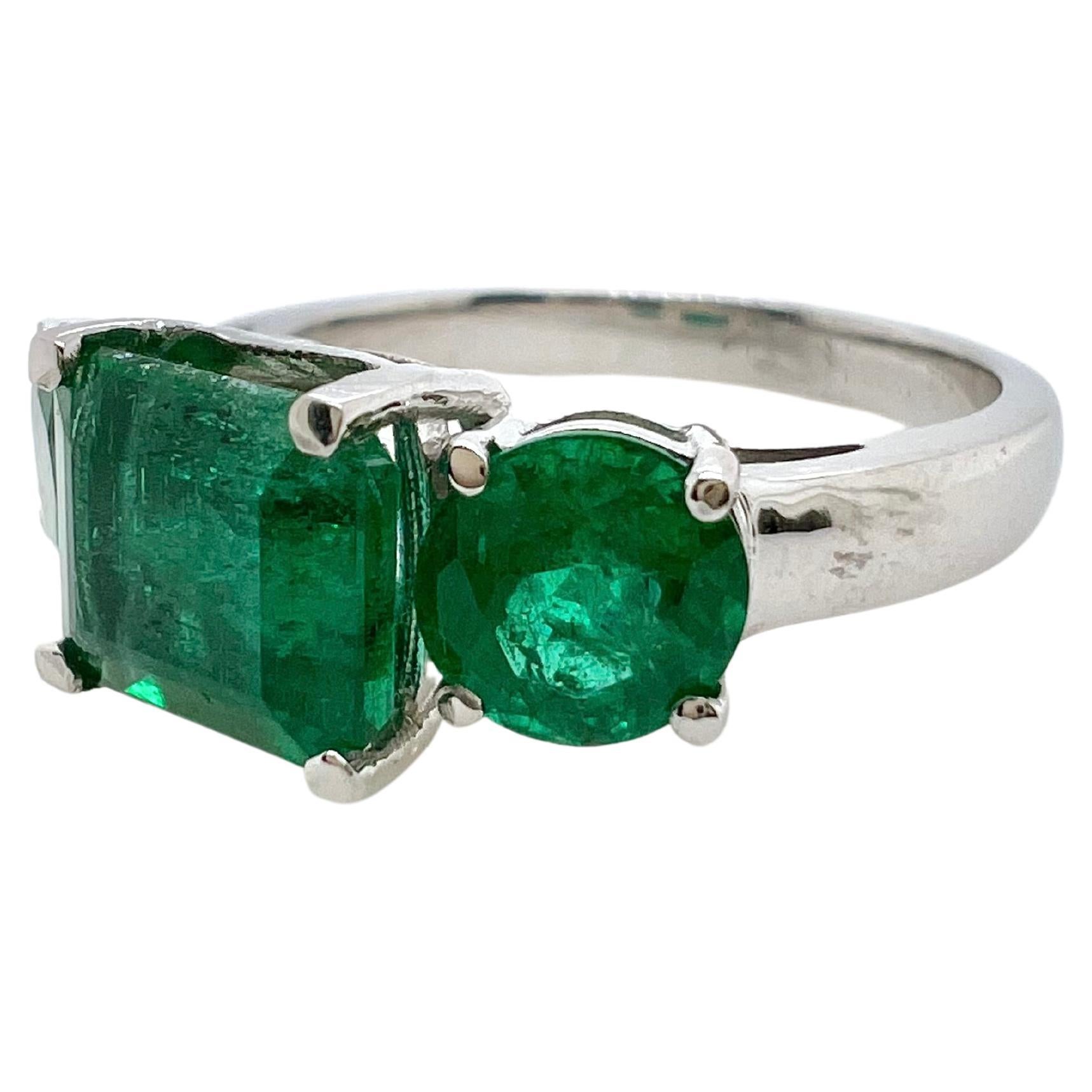 This unique three stone ring will grasp everyone's attention!  The round cut emerald accompany the center emerald cut emerald to give a true, emerald green ring. 


Size: 6.75 (can be size)
Emerald: 1.97 cts, Emerald Cut
Emeralds: 1.44 cts, Round
