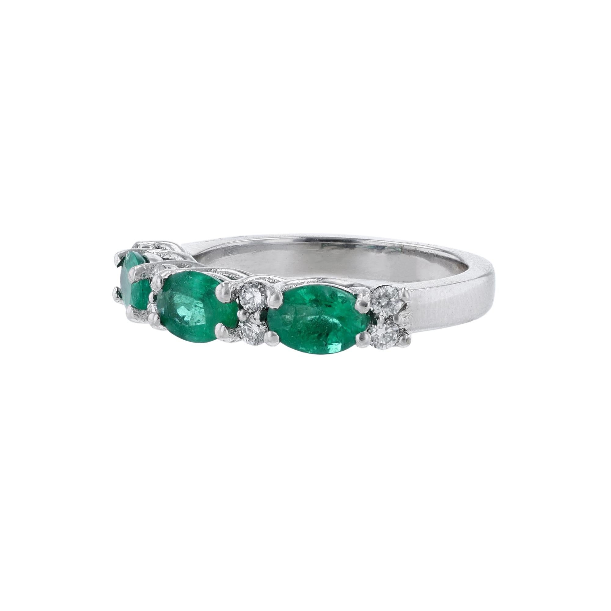 This ring is made in 18K white gold. It features 3 oval cut emeralds weighing 1.18 carats. Also features 8 round cut diamonds weighing 0.22 carat. The stones are all set with prongs. The ring has a color grade (H) and a clarity grade (SI2).