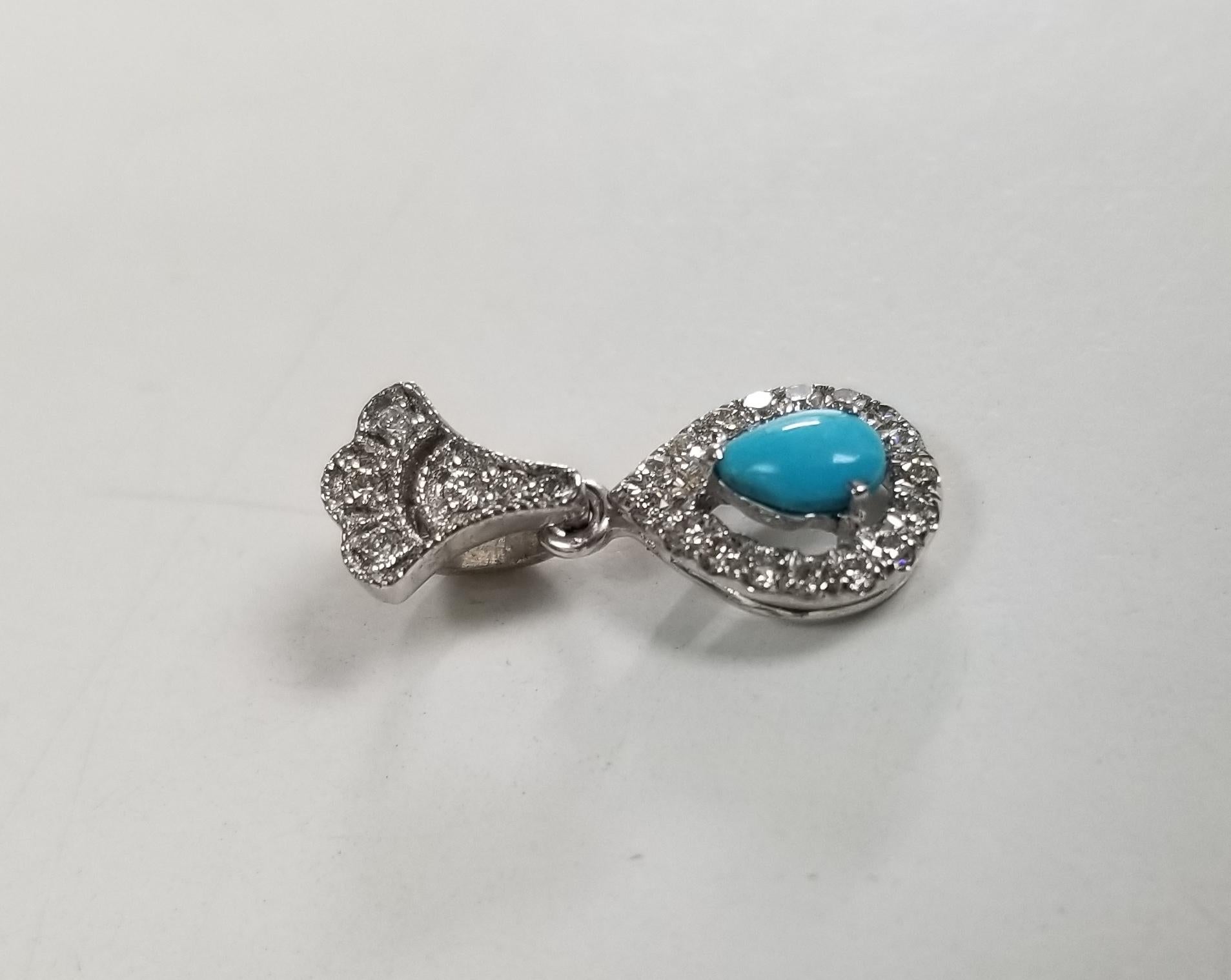 14k white gold turquoise and diamond pendant with 23 round diamonds weighing .20pts. and a pear shape turquoise with no chain.