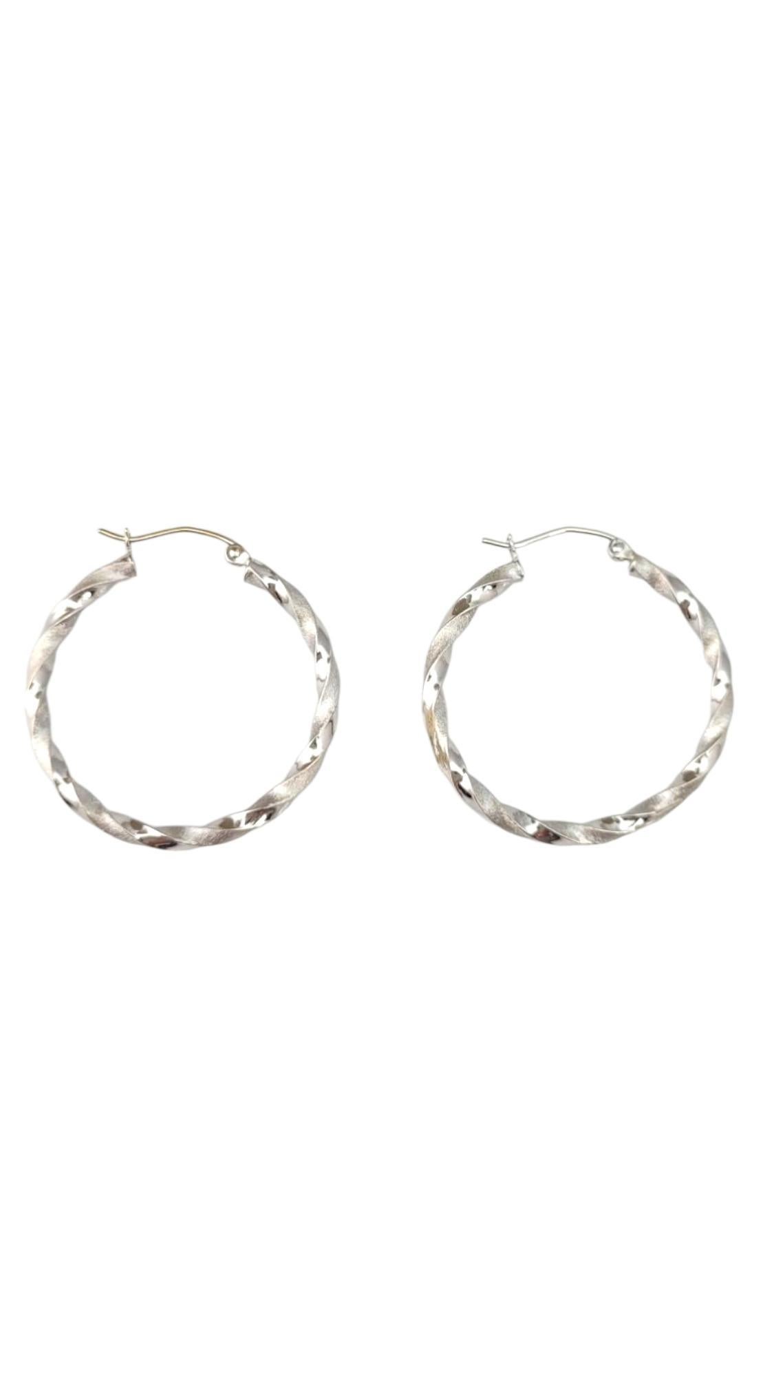 14K White Gold Twisted Hoop Earrings -

These twisted hoop earrings feature a graceful, spiral design that adds dimension and flair to a timeless silhouette. Their textured twist catches the light beautifully, offering a modern yet elegant look