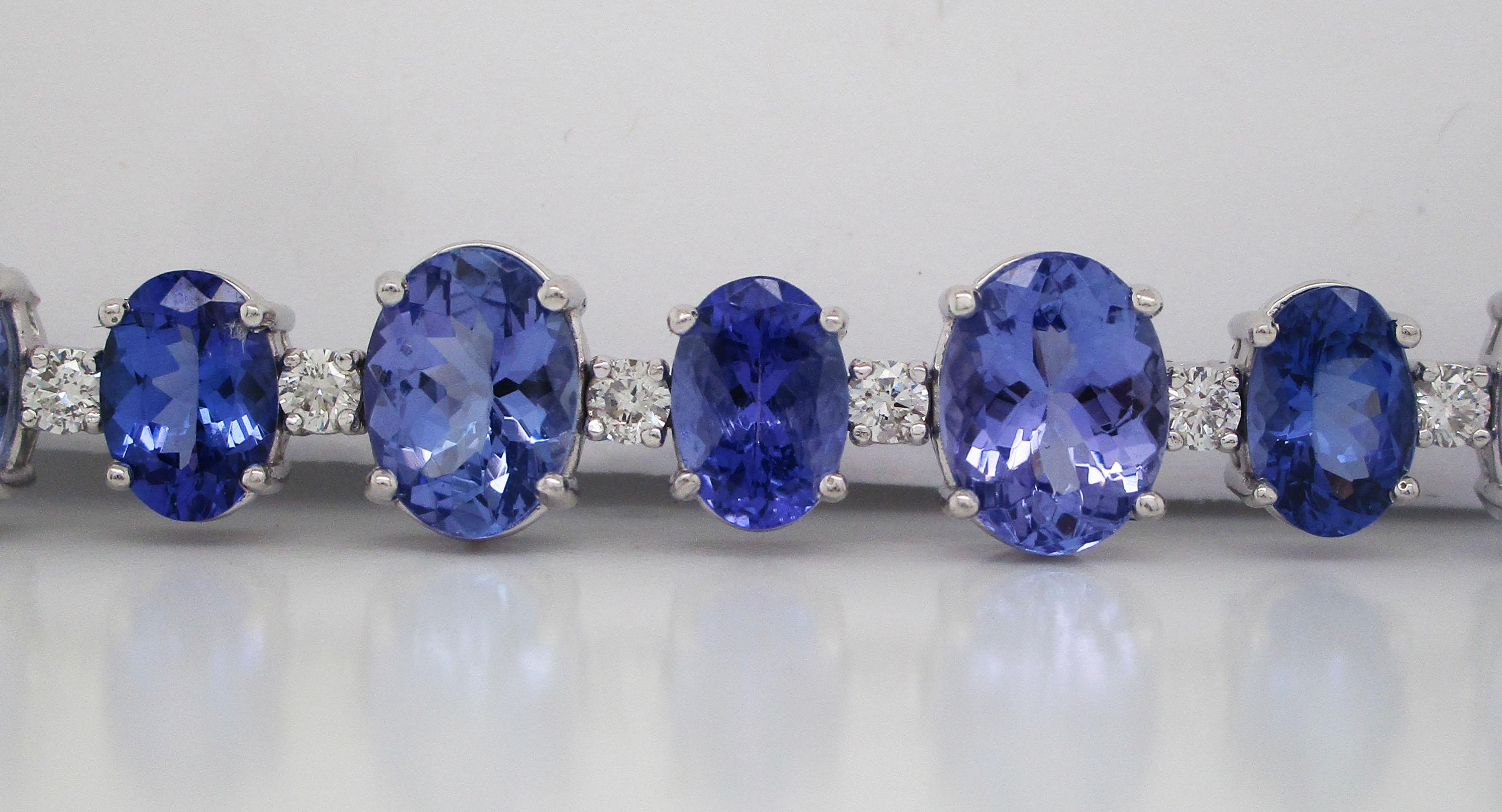 This incredible bracelet is in 14k white gold and features a remarkable array of oval-shaped tanzanite stones in two distinct shades separated by brilliant white diamonds! The beautiful contrast of the two shades of tanzanite and the bright diamonds