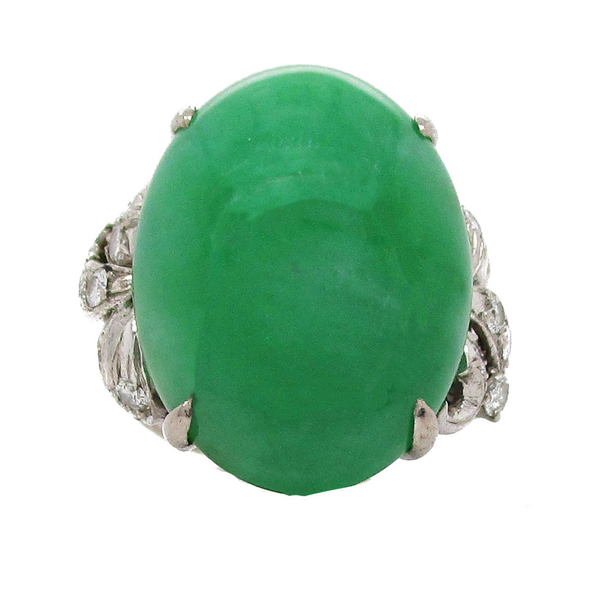 This stunning ring features a gorgeous, untreated, natural green jade cabochon centerpiece. The jade is flanked on each side by a stunning array of diamonds adding up to a total weight of 0.5 carats. The ring itself is bright 14 karat white gold.