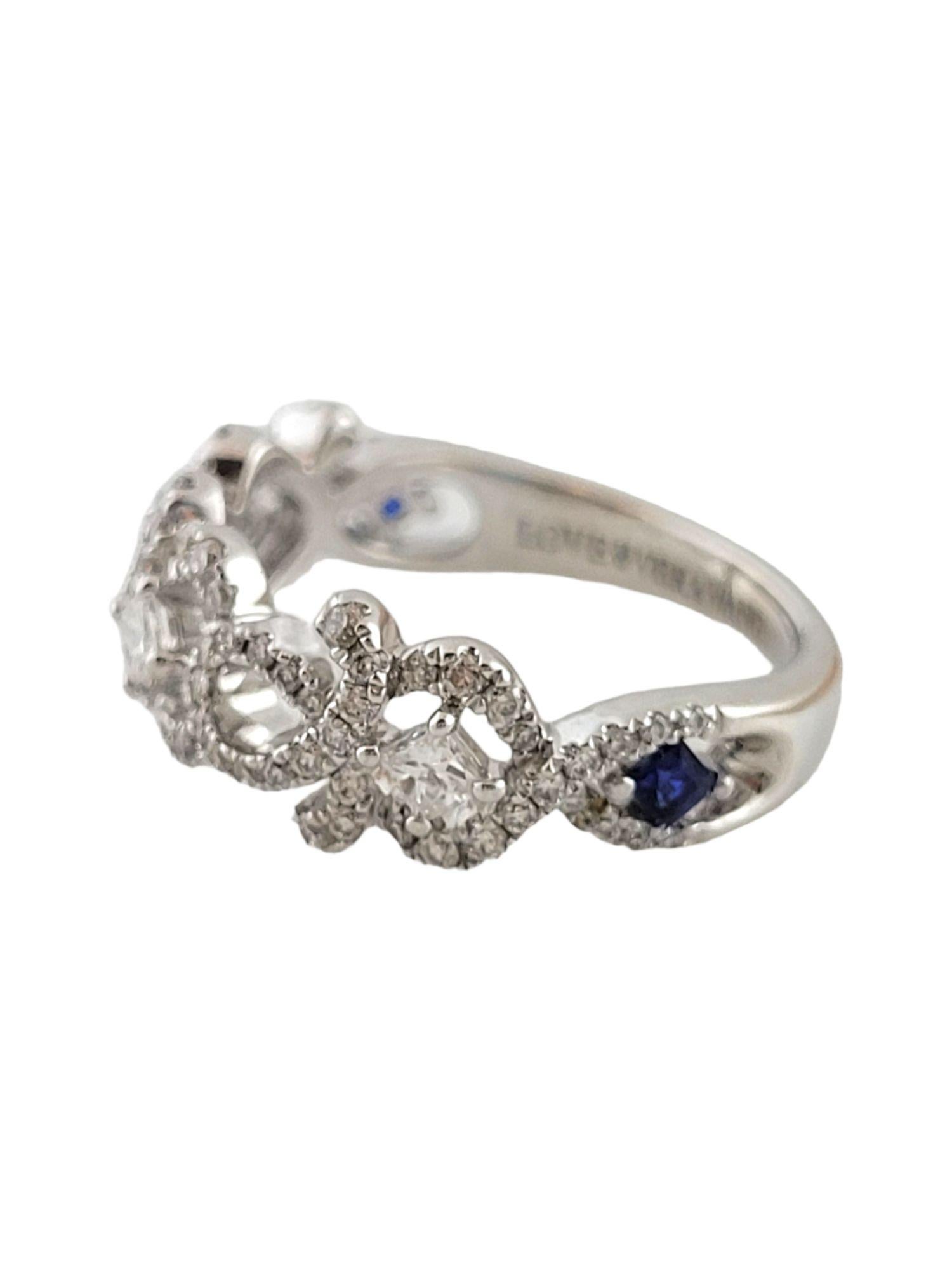 This gorgeous 14K white gold ring has 79 round cut diamonds decorated around 3 princess cut diamonds and 2 square cut sapphires for a beautiful look!

82 diamonds total

2 blue sapphires total

Approximate total diamond weight: .54 cttw

Diamond