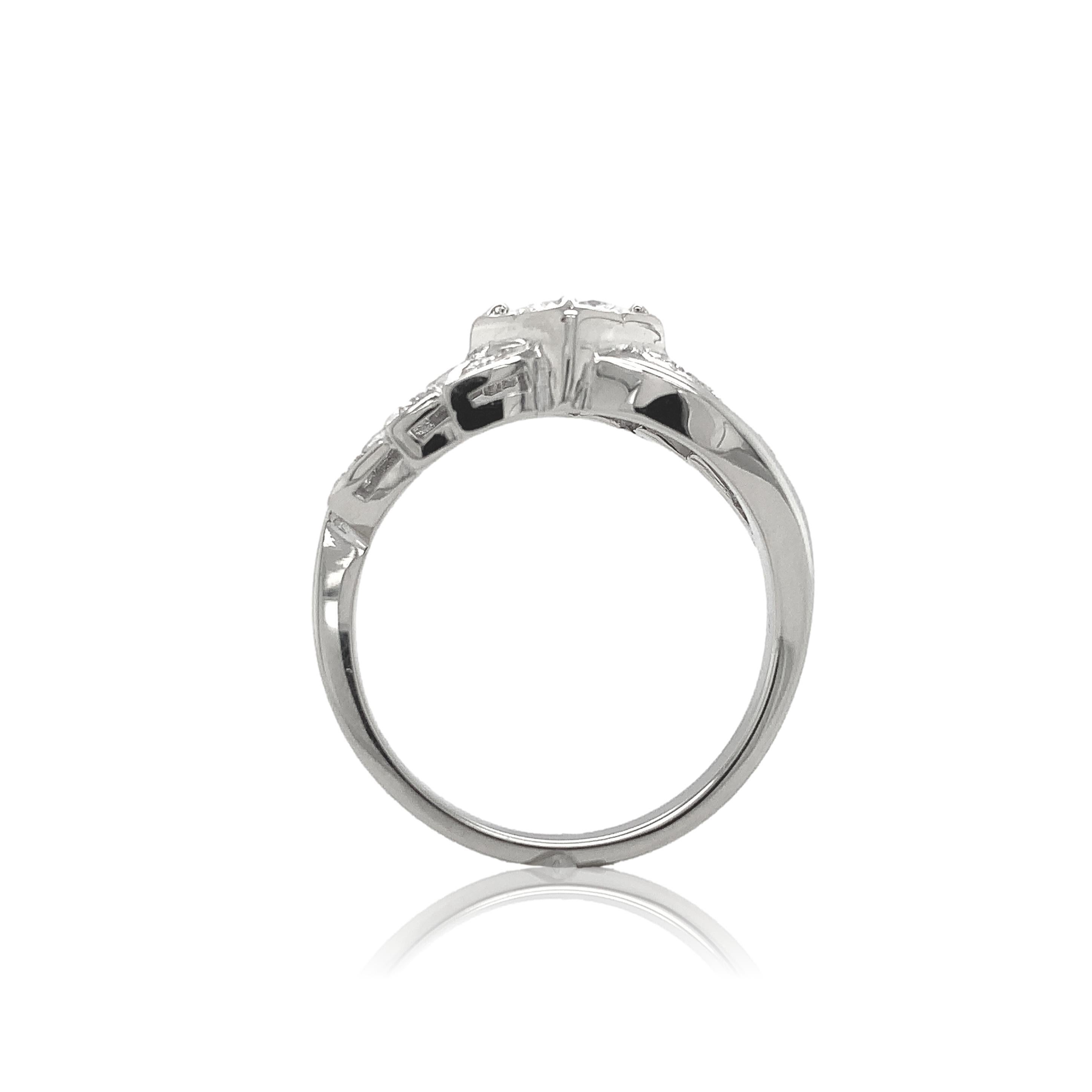 Vintage .50ct diamond engagement ring. The GIA report #2221447156 states round brilliant cut natural diamond measuring 5.22mm x 5.31mm x 2.93mm with G color and SI2 clarity. There is a cavity on one side of the diamond. There are 10 small round