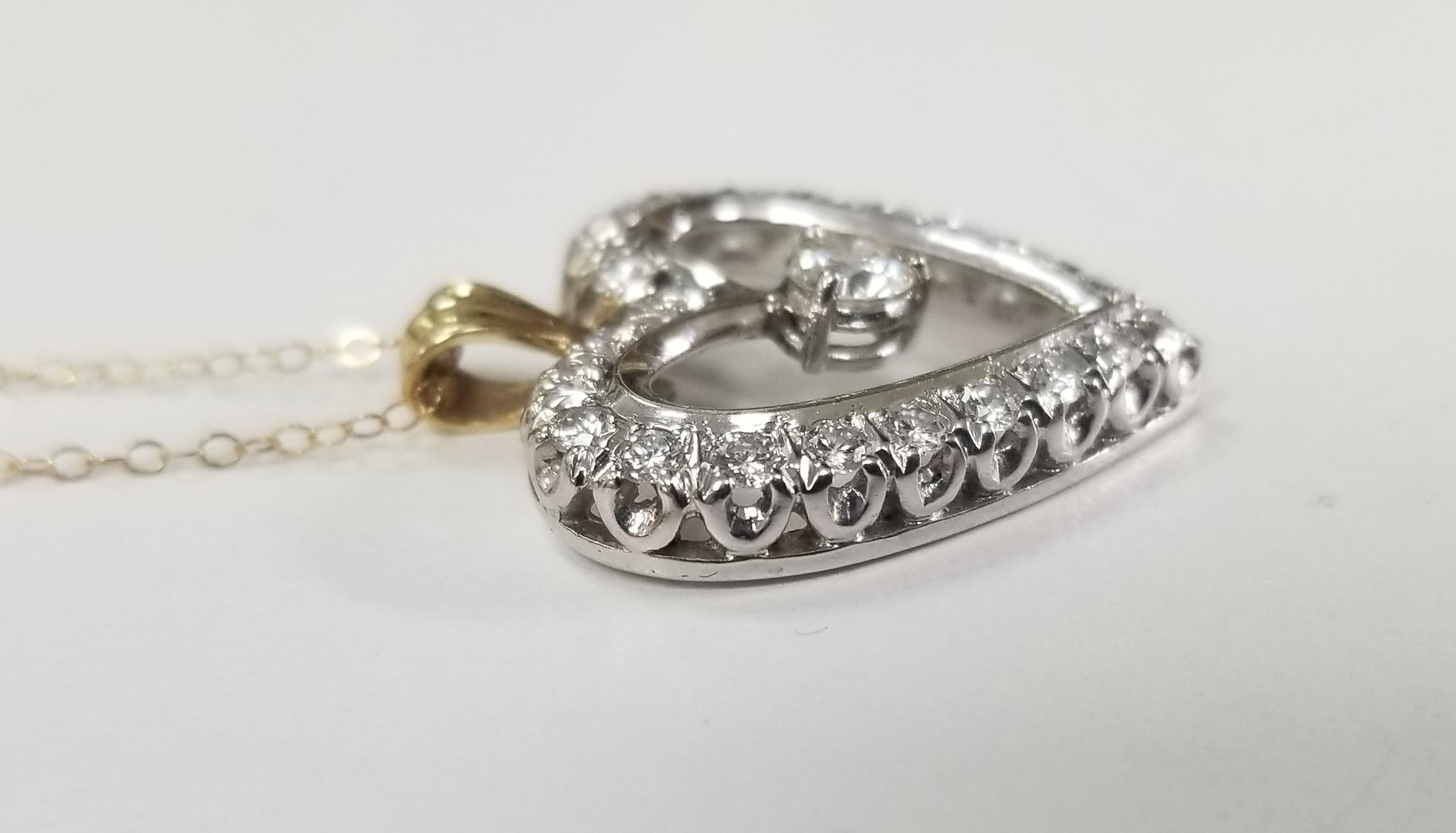 14k white gold vintage Art Deco Style diamond heart pendant, containing 23 round full cut diamonds of very fine quality weighing 1.35cts. on 16 inch 14k yellow gold chain 15 inch.