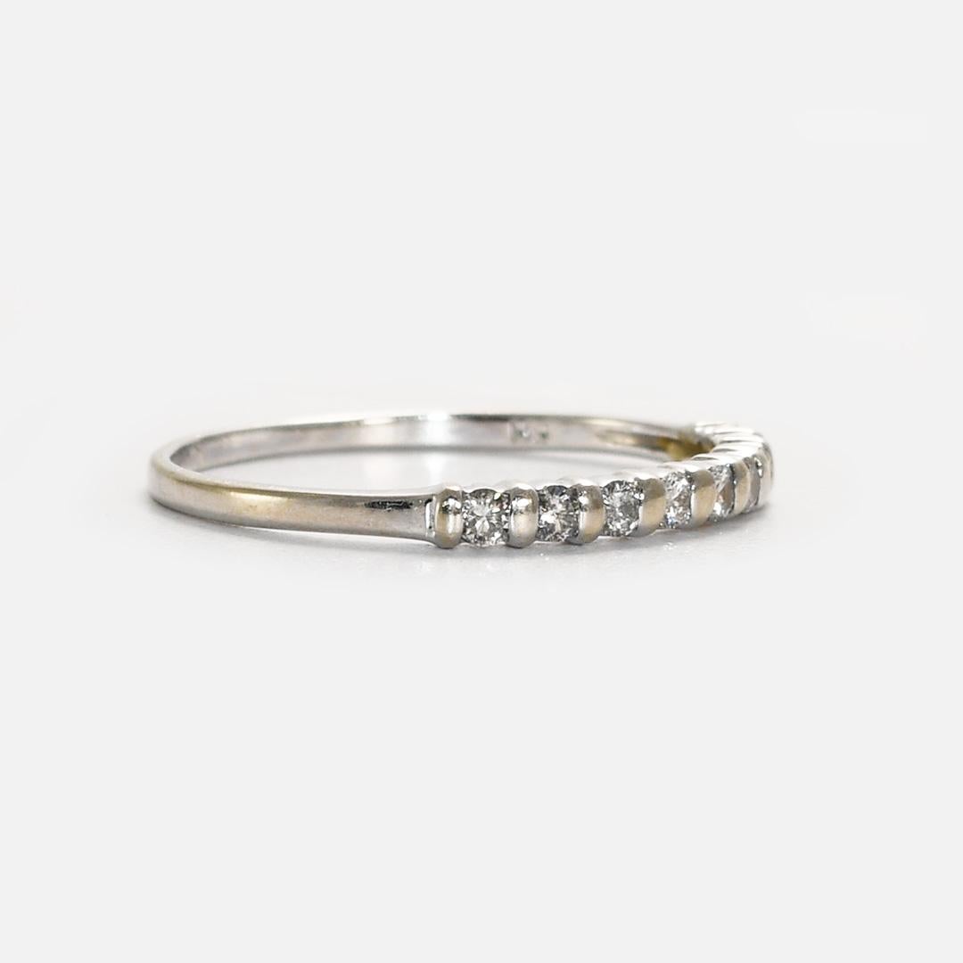 14k White Gold Diamond Band.
There is .15tdw in round brilliant cuts. 
Stamped 14k.
weighs 1.3g.
Size 8 3/4, can be sized up or down for an additional fee. 