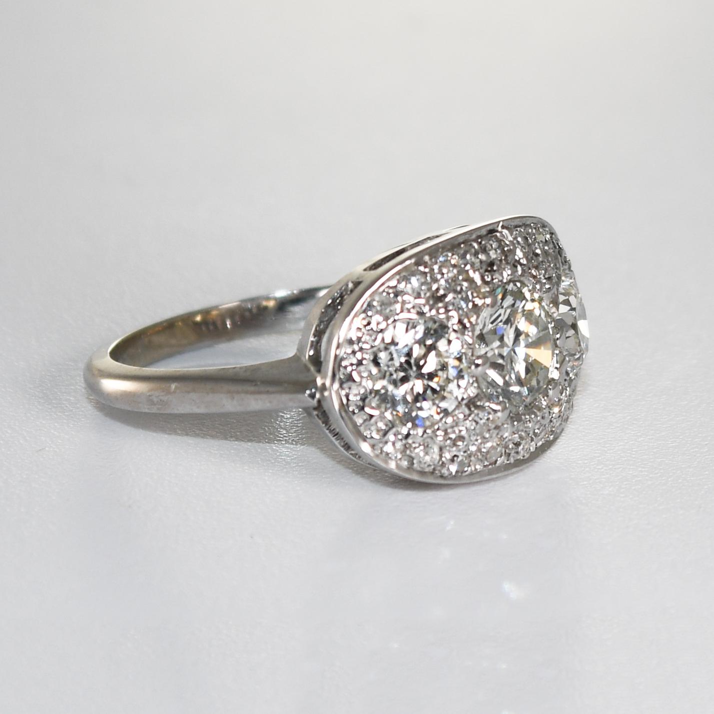 Ladies' vintage 14k white gold and diamond ring.
The ring is stamped 14k and weighs 4.3 grams.
The center diamond is .89 carats, J to K color, Si clarity.
The two side diamonds are old-Euro cuts,  .50 carats each, J to K color, VS to SI
