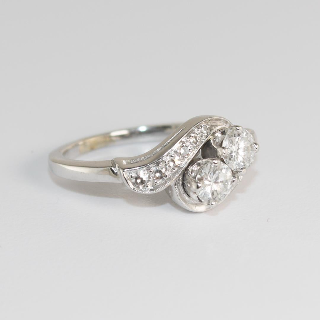 Ladies vintage 14k white gold and diamond ring.
Tests 55% gold with an XRF metals analyzer.
The gross ring weight is 3.5 grams.
The two center diamonds are round brilliants,  .25 carats each, .50 total carats, G to H color, Vs clarity.
The side