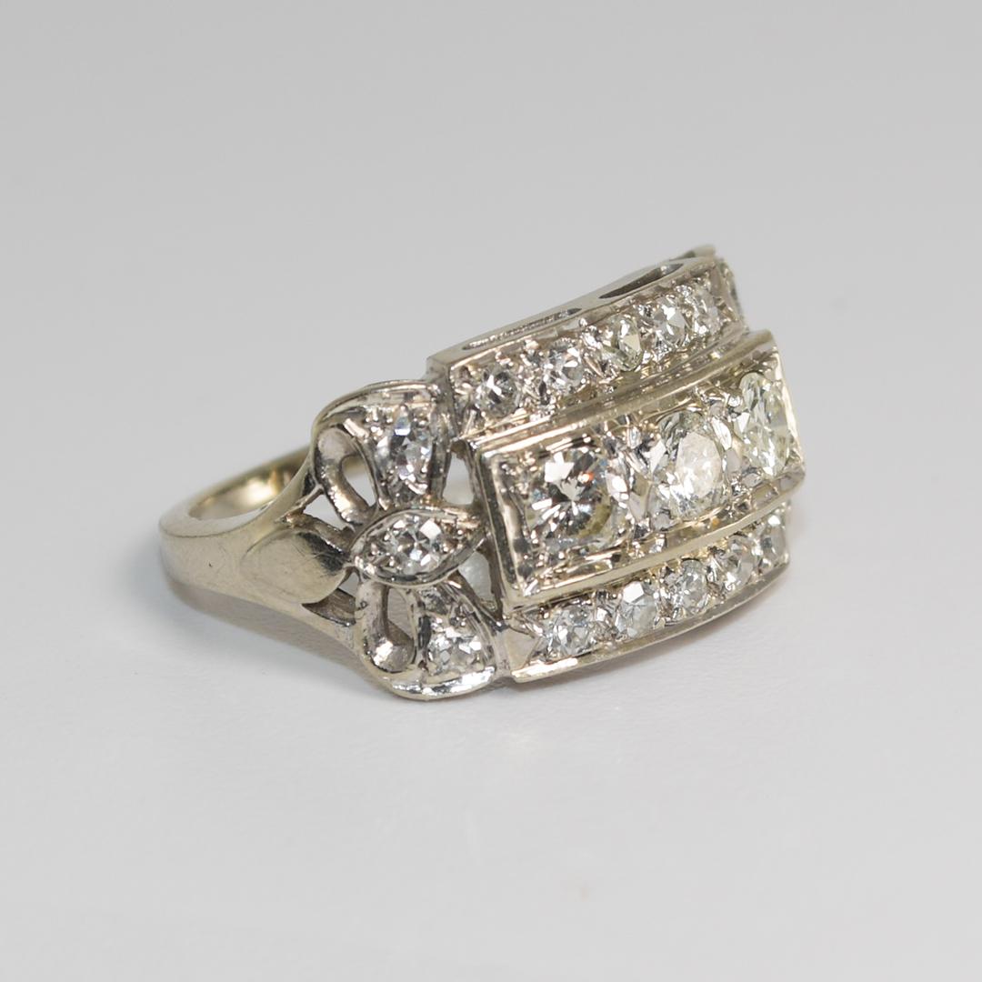 Ladies vintage ring 14k white gold and diamond ring.
Stamped 14k and weighs 4.3 grams gross weight.
The center diamonds are round brilliant cuts, H, i, j color range, Si to i1 clarity.
The side diamonds are single-cuts, H to I color, mostly Vs