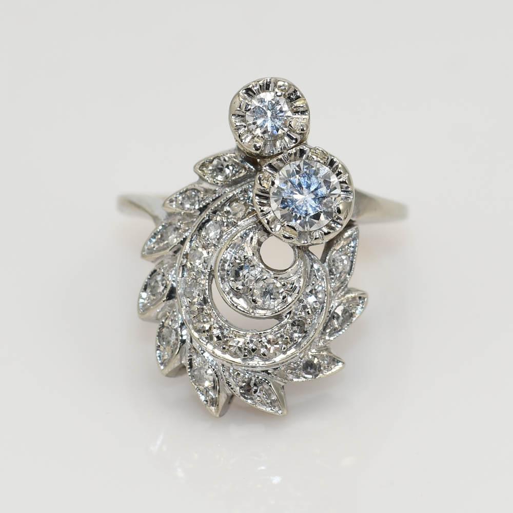 Ladies vintage diamond ring with 14k white gold setting.
Stamped 14k and weighs 6.7 grams.
The two largest diamonds are a .45 carat and .10 carat round briliant cut, H,i, j color range, Vs clarity, good cuts.
The side diamonds are single-cuts, .35