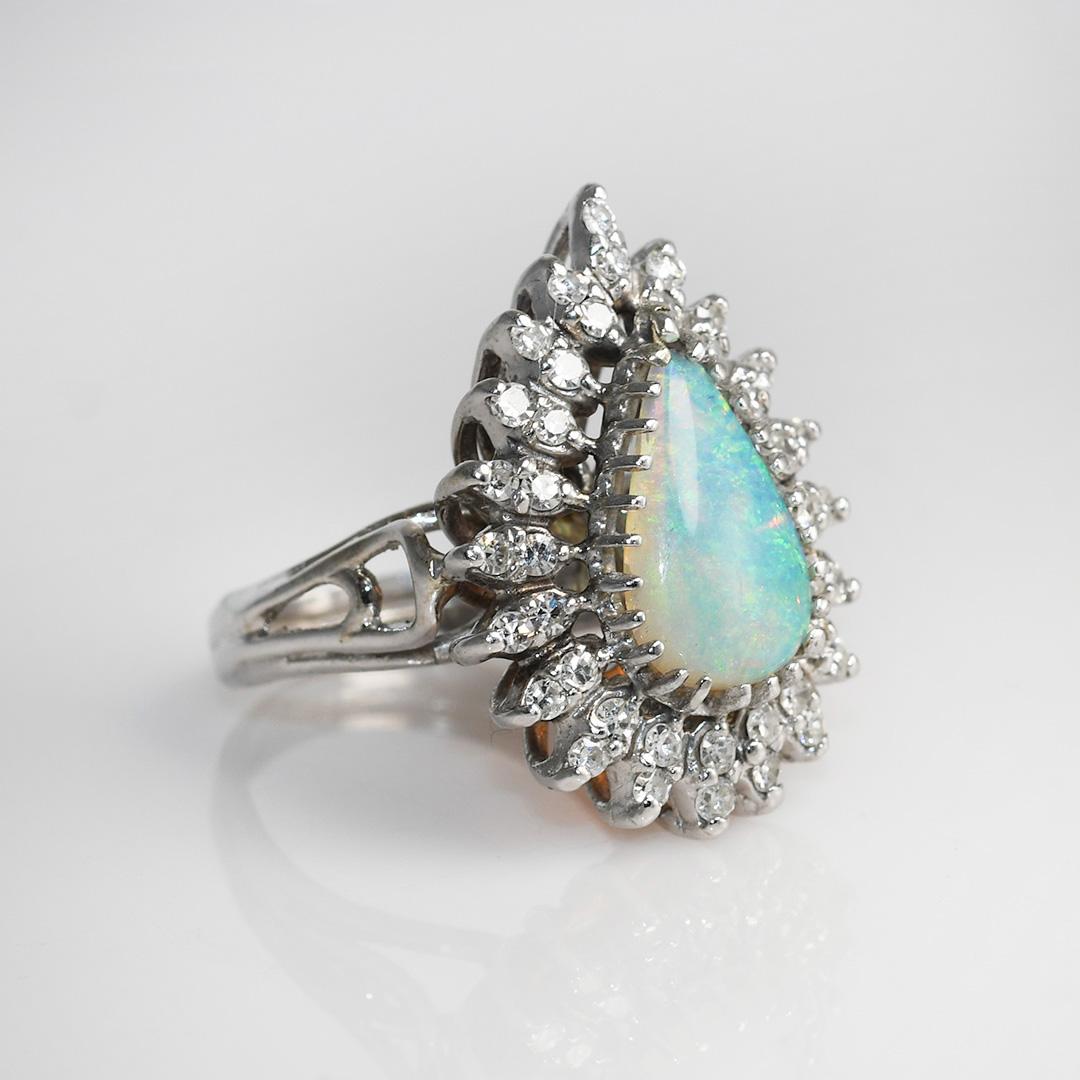 14K White Gold Vintage Opal & Diamond Ring, 8.7g, .35tdw
Ladies Australian opal and diamond vintage ring in 14k white gold setting.

Tests 56.5% gold using a XRF metals analyzer. Gross weight is 8.7 grams.

The solid piece of  opal is a pear shape,