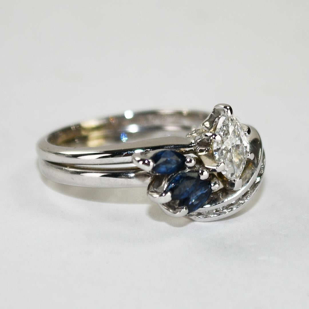 Ladies' Vintage diamond and blue sapphire ring in a 14k white gold setting.
Stamped 14k and weighs 4.1 grams.
The center diamond is a marquise shape, .33 carats, I color, SI clarity.
The marquise shape sapphires are natural, .30 total carats, deep