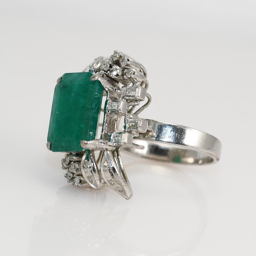 Ladies vintage emerald and diamond ring with 14k white gold setting.

Stamped 14k and weighs 7.8 grams gross weight.

The emerald looks to be hydro thermal lab grown, measuring 12.7mm by 9.3mm and 5.2mm deep, approximately 4.00 carats.

The clarity