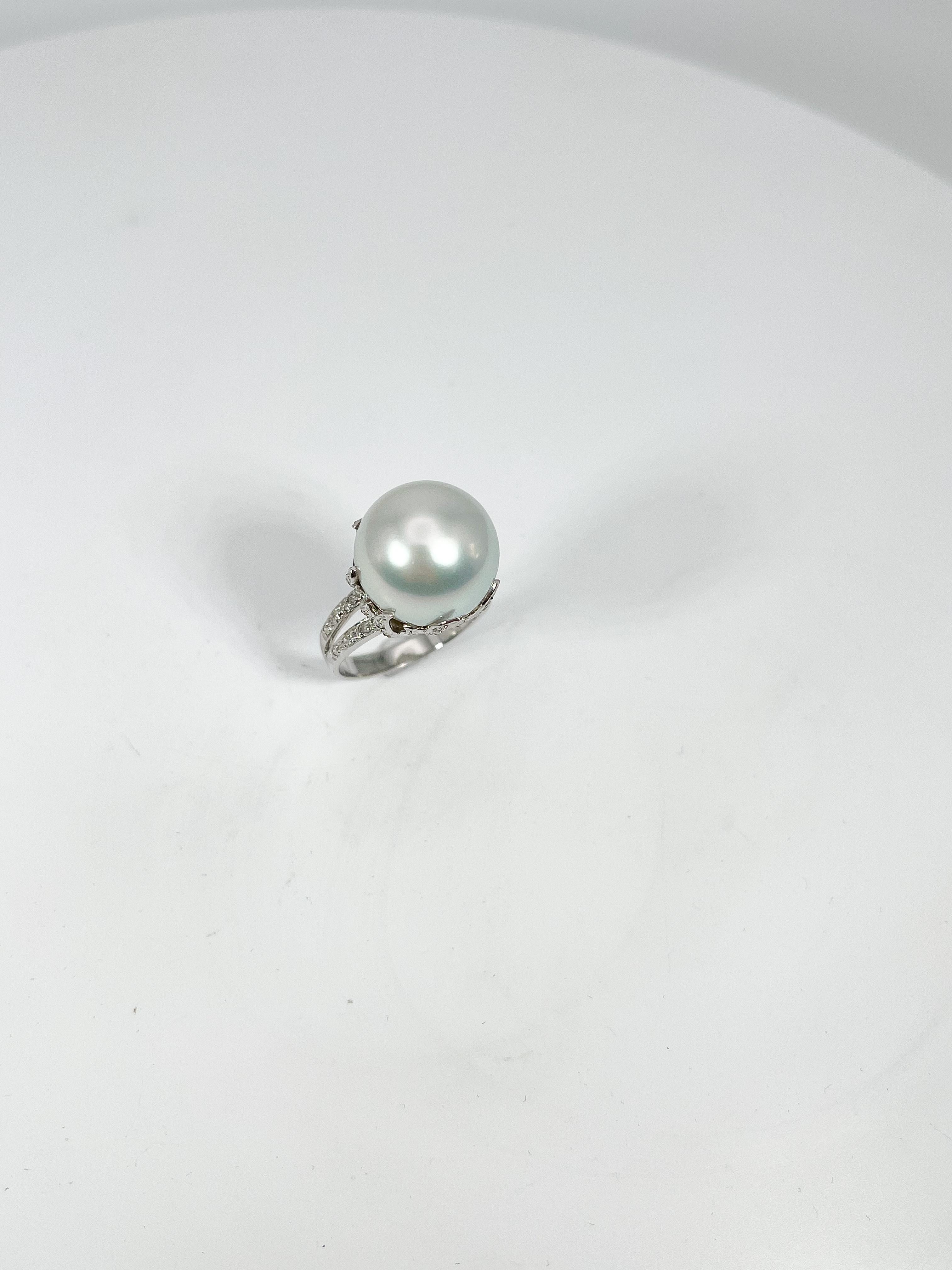 14k white gold white pearl and diamond ring. The diamonds in this ring are all round, the width of the pearl is 14 mm, the ring is a size 6 1/2, and it has a total weight of 8.2 grams.