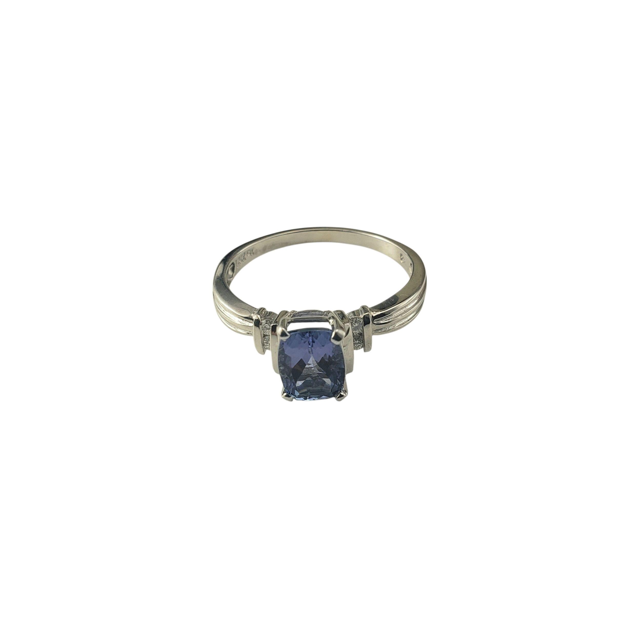 14K White Gold Tanzanite and Diamond Ring Size 9.5 JAGi Certified-

This elegant 14K white gold ring features a vibrant cushion cut tanzanite at its center flanked by two round brilliant cut diamonds on each side, adding a touch of