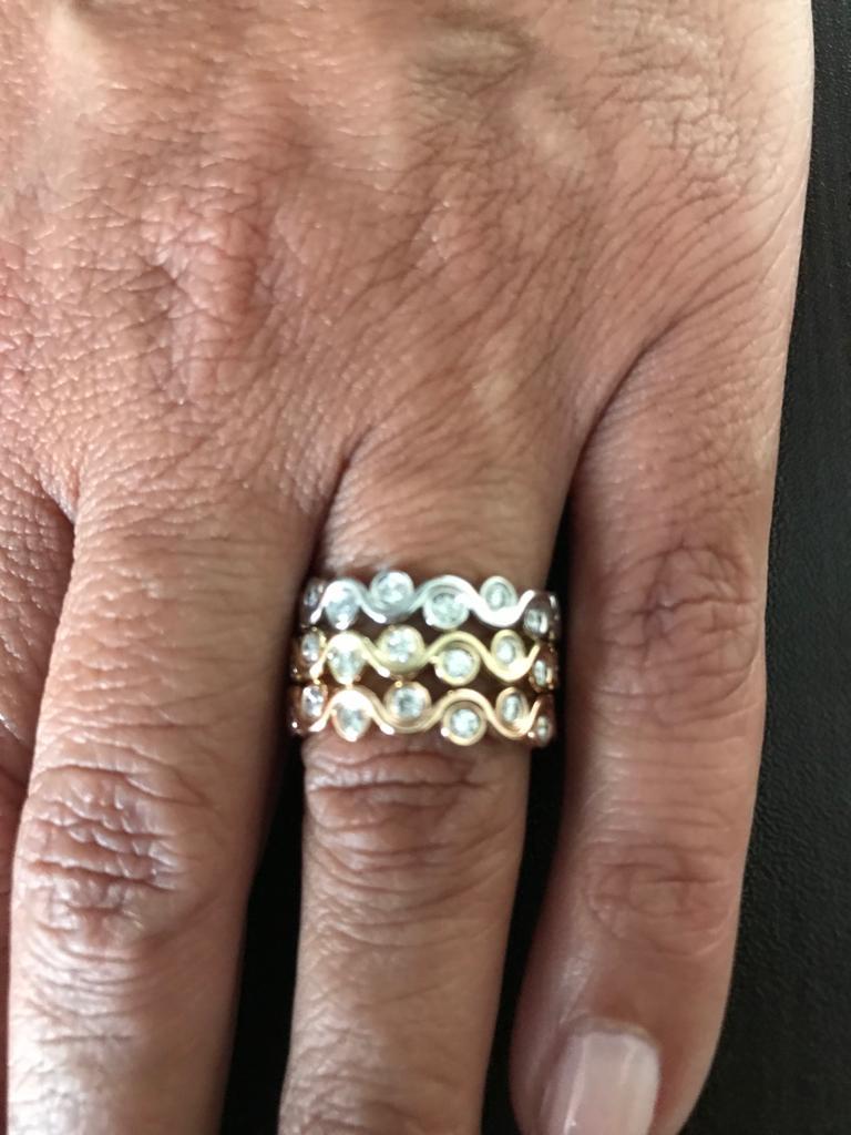 Stackable bezel rings set in 14K white, yellow, and rose gold. The total weight of the ring set is 1.45 Carats. The color of the stones are G-H, the clarity is SI. These rings are sold as a set. The size of each ring is a 6.5.