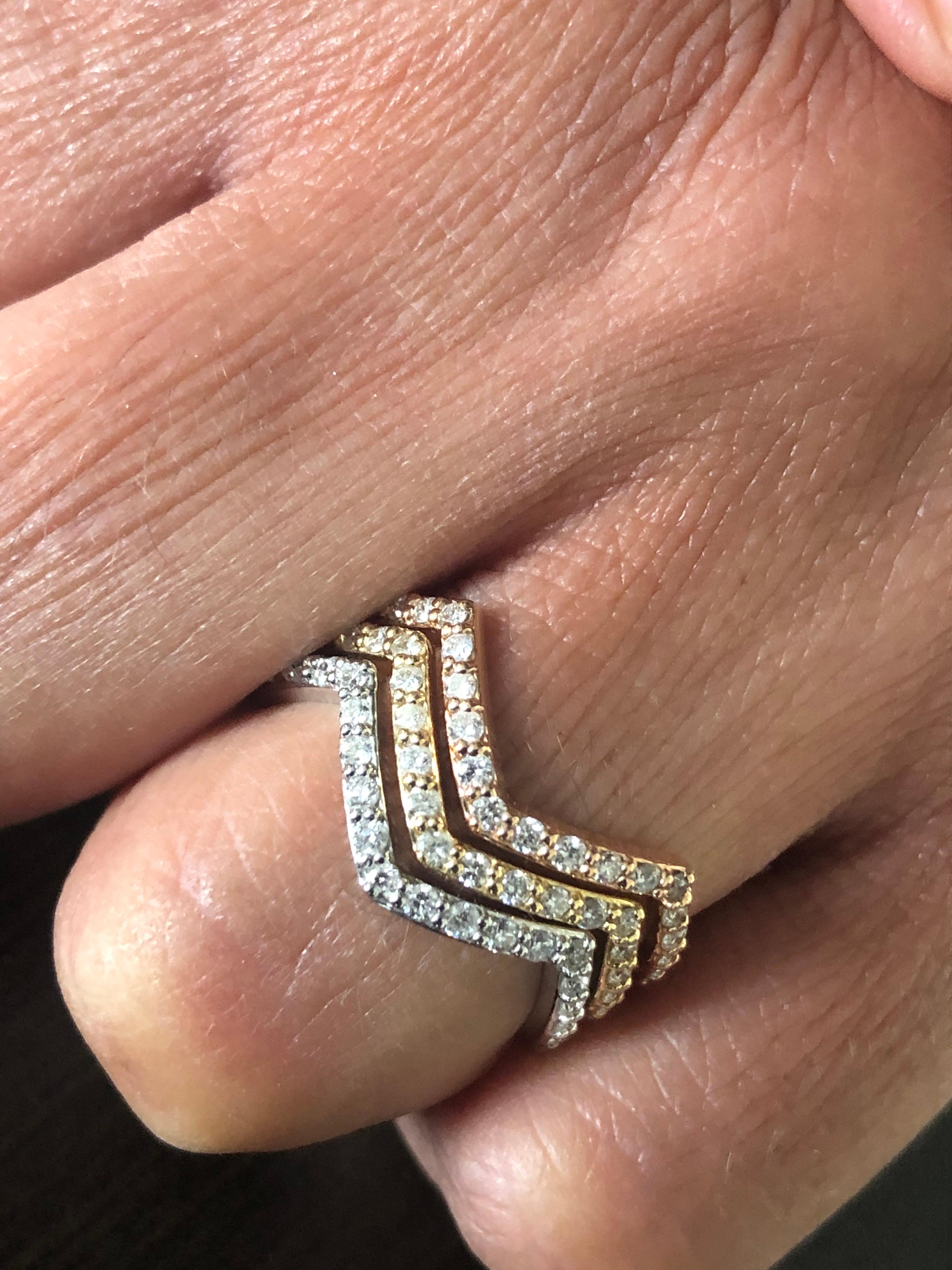 Tricolor zigzag diamond rings set in 14K gold. Each ring weighs 0.40 Carats. The color of the stones are H, the clarity is SI1-SI2. Each band is a size 7. The rings are sold as a set.