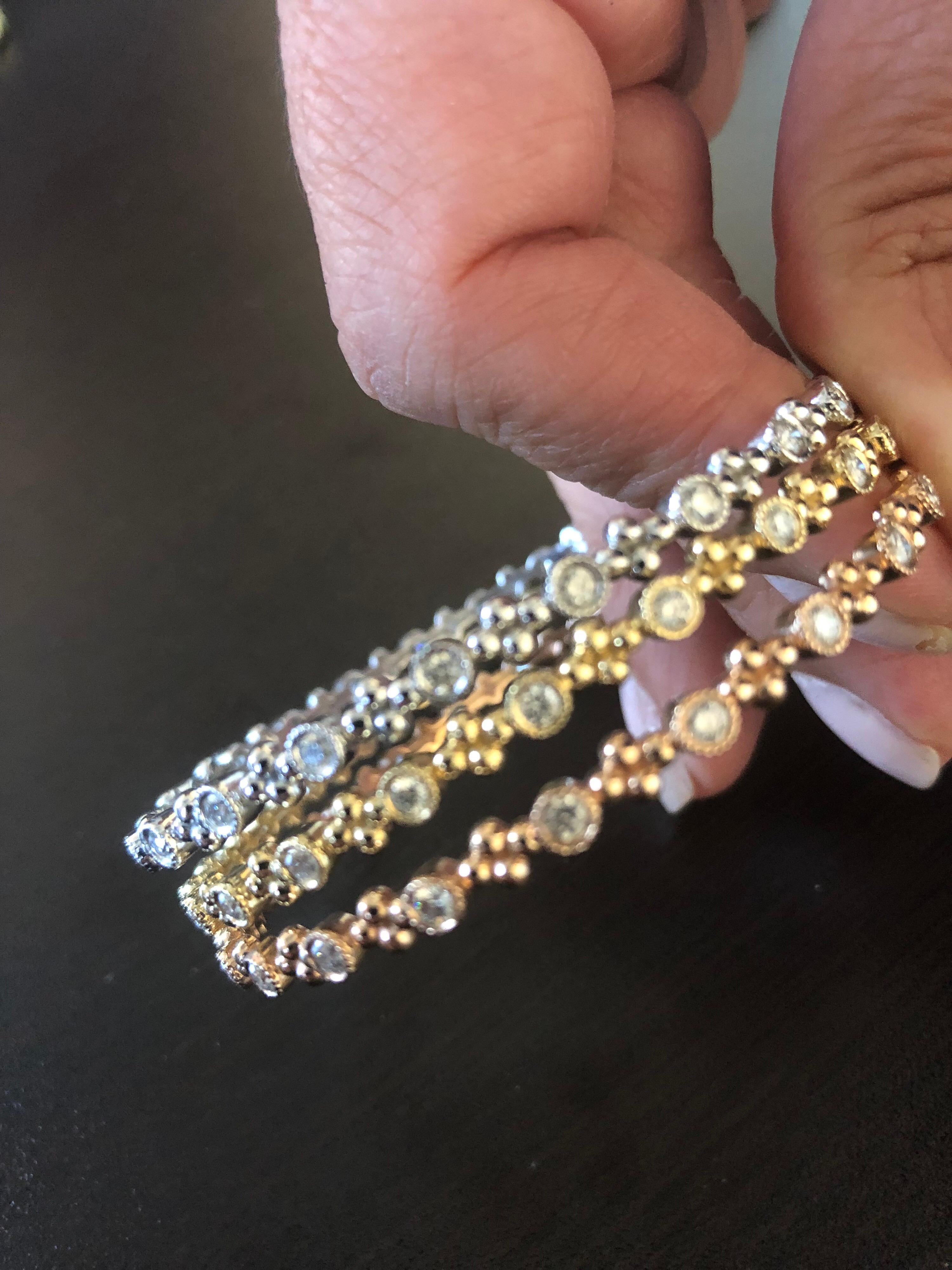 Slip on diamond bangles sold individually. Each stone is set in an engraved bezel. The total carat weight of each bangle is 1.15. The color of the stones are G-H, clarity is SI1-SI2. The bangles are measured at 2 1/2 inches in diameter, but can be