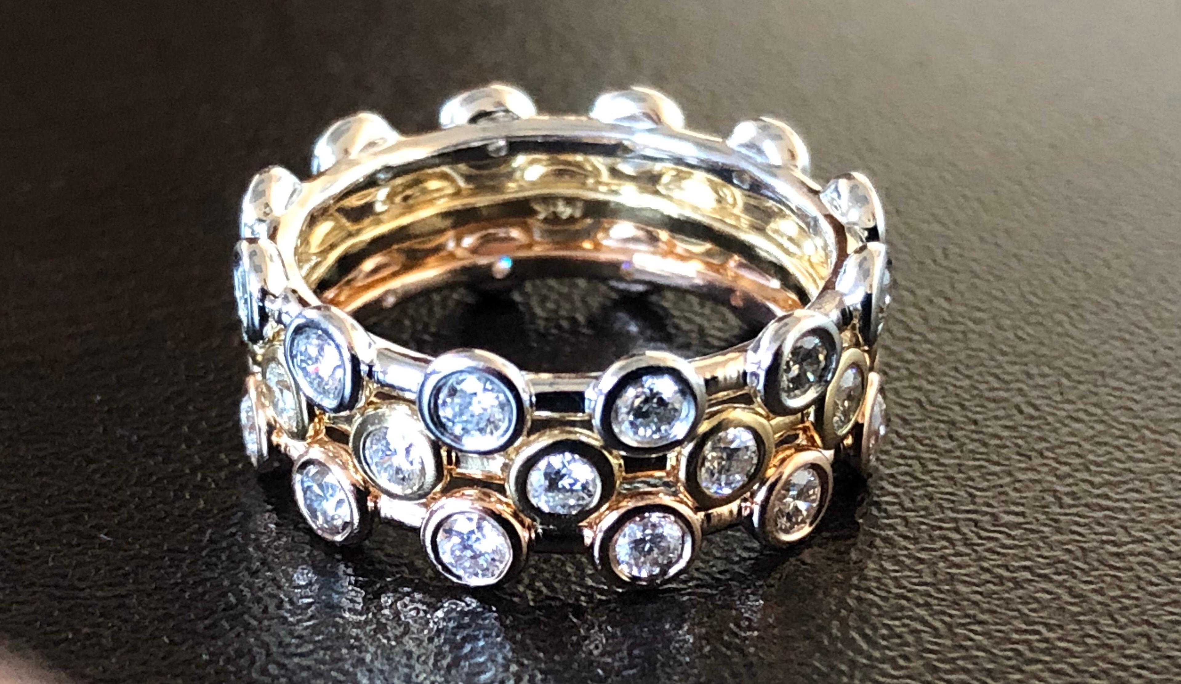 Tricolor bezel diamond rings set in 14K gold. The rings are each set with 12 diamonds and the total carat weight is 0.48 a ring. The color of the stones are G-H, the clarity is SI. Each ring is a size 6.5. The stackable rings are sold as a set.