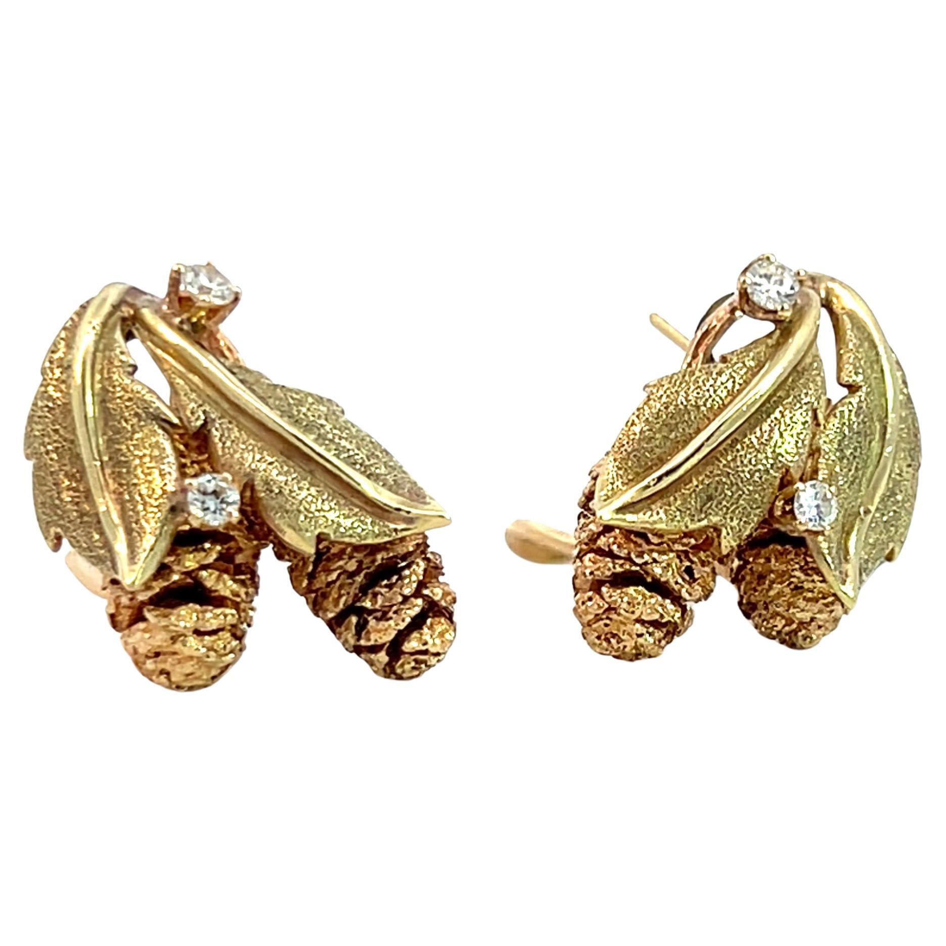 Experience the beauty of nature with these 14k yellow and rose gold pinecone diamond leaf earrings. They feature rose gold pinecones nestled in yellow gold leaves and sparkling diamonds for added brilliance. Intricate engraving and detailed