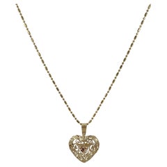 Collier pendentif cœur filigrane en or jaune et rose 14 carats