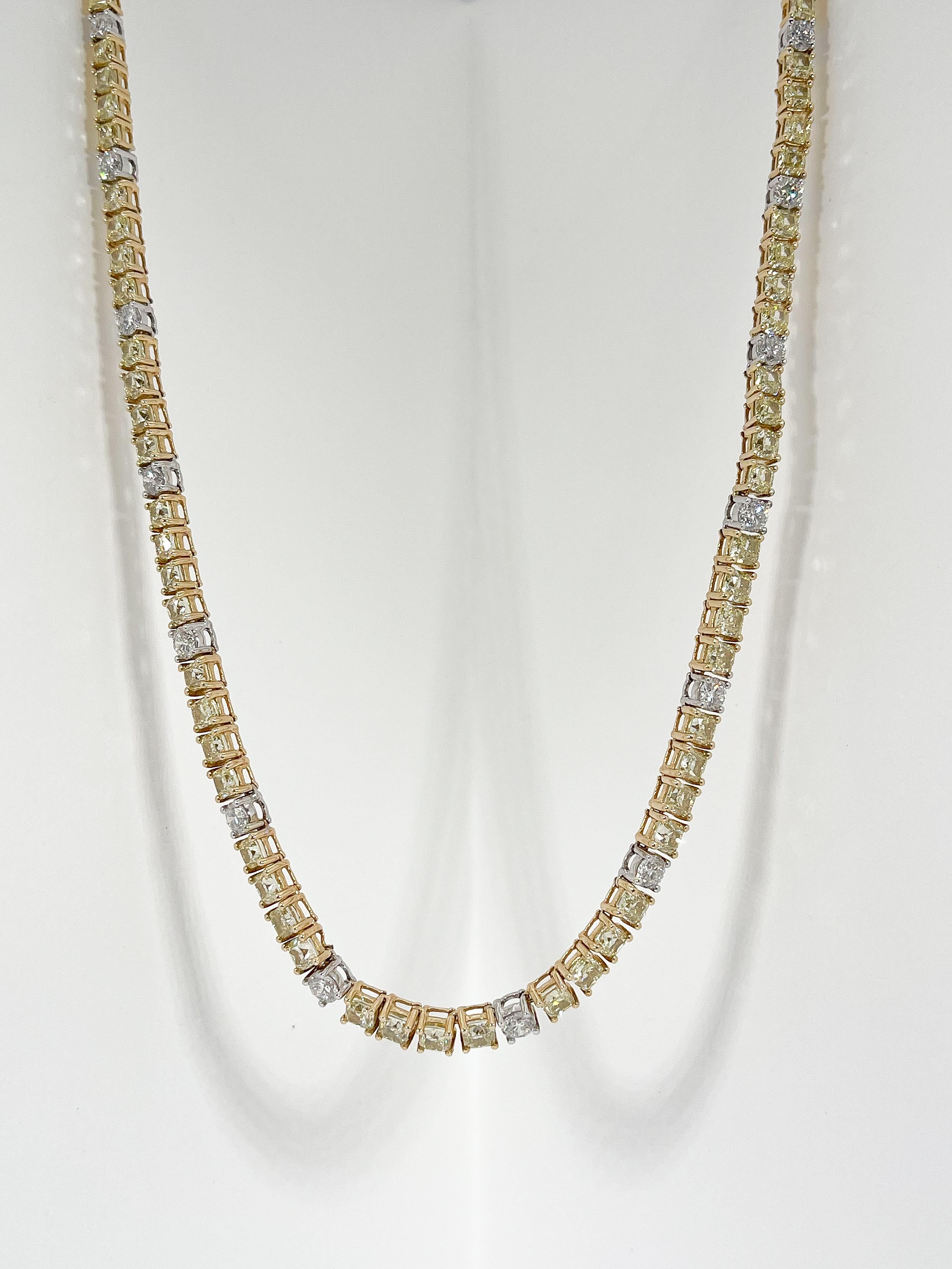 Ladies 14k yellow and white gold graduated Riviere style necklace prong set with yellow cushion brilliant cut diamonds and near colorless round brilliant cut diamonds. The necklace measures 18 inches long by 3mm-5mm wide and is finished with a box