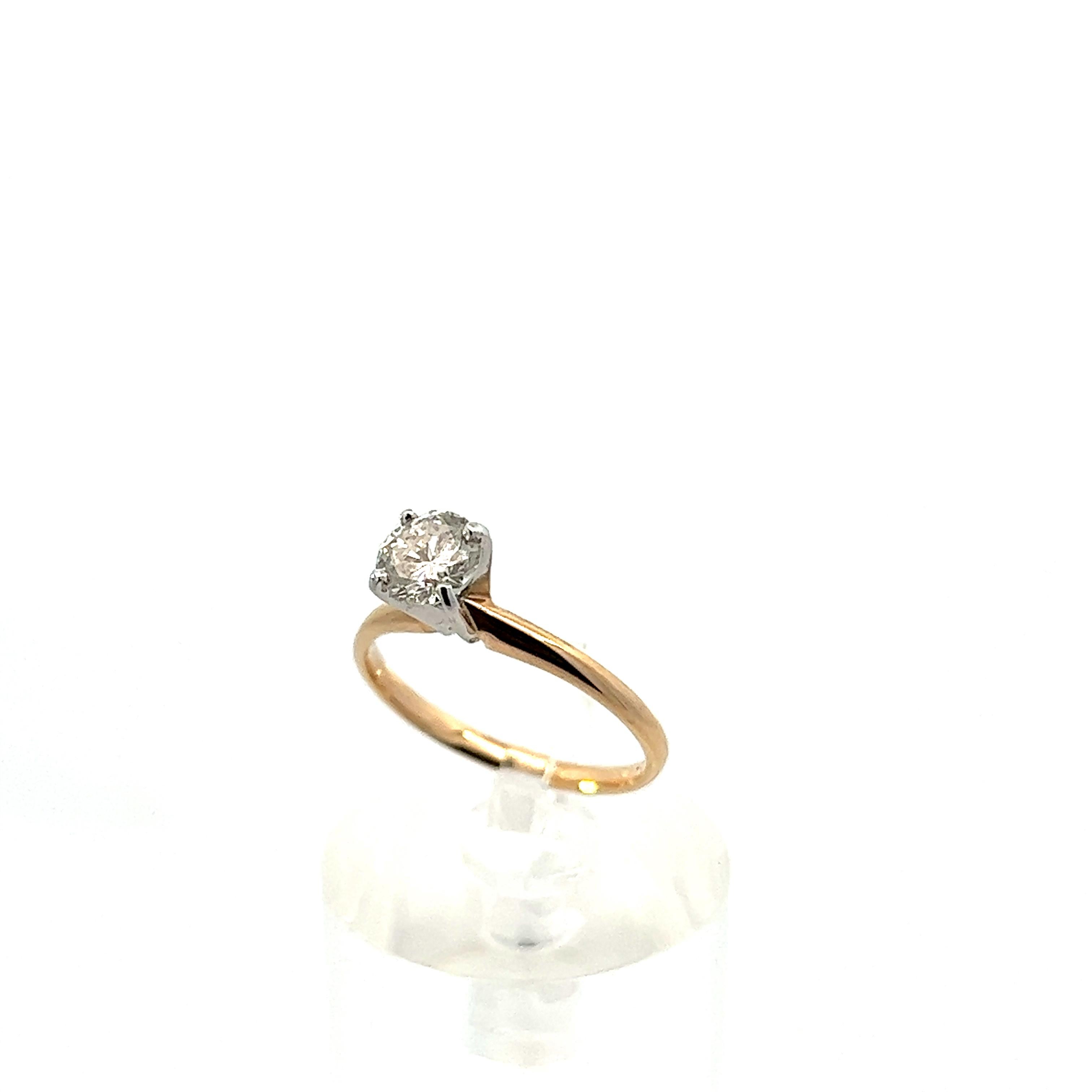 This contemporary 14k yellow and white gold diamond solitaire ring is the embodiment of sophistication and beauty. The band is made in gorgeous 14k yellow gold, while the solitaire diamond is set in a 14k white gold, to further enhance the sparkle