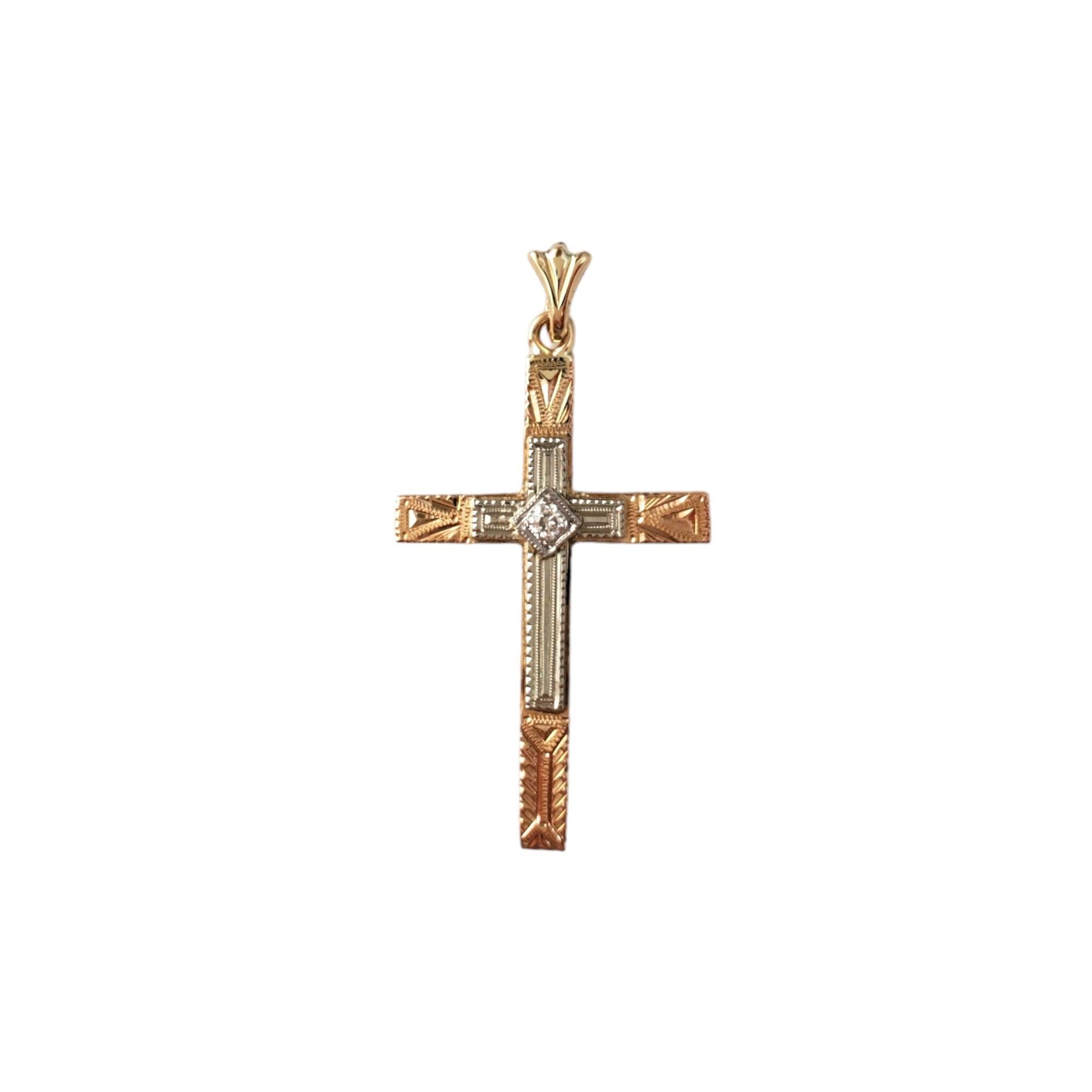 Vintage 14 Karat Yellow and White Gold Diamond Cross Pendant - 

This beautiful cross pendant features 1 European cut diamond crafted in meticulously detailed 14K yellow and white gold. 

Approximate total diamond weight:  0.04cts.

Diamond color:
