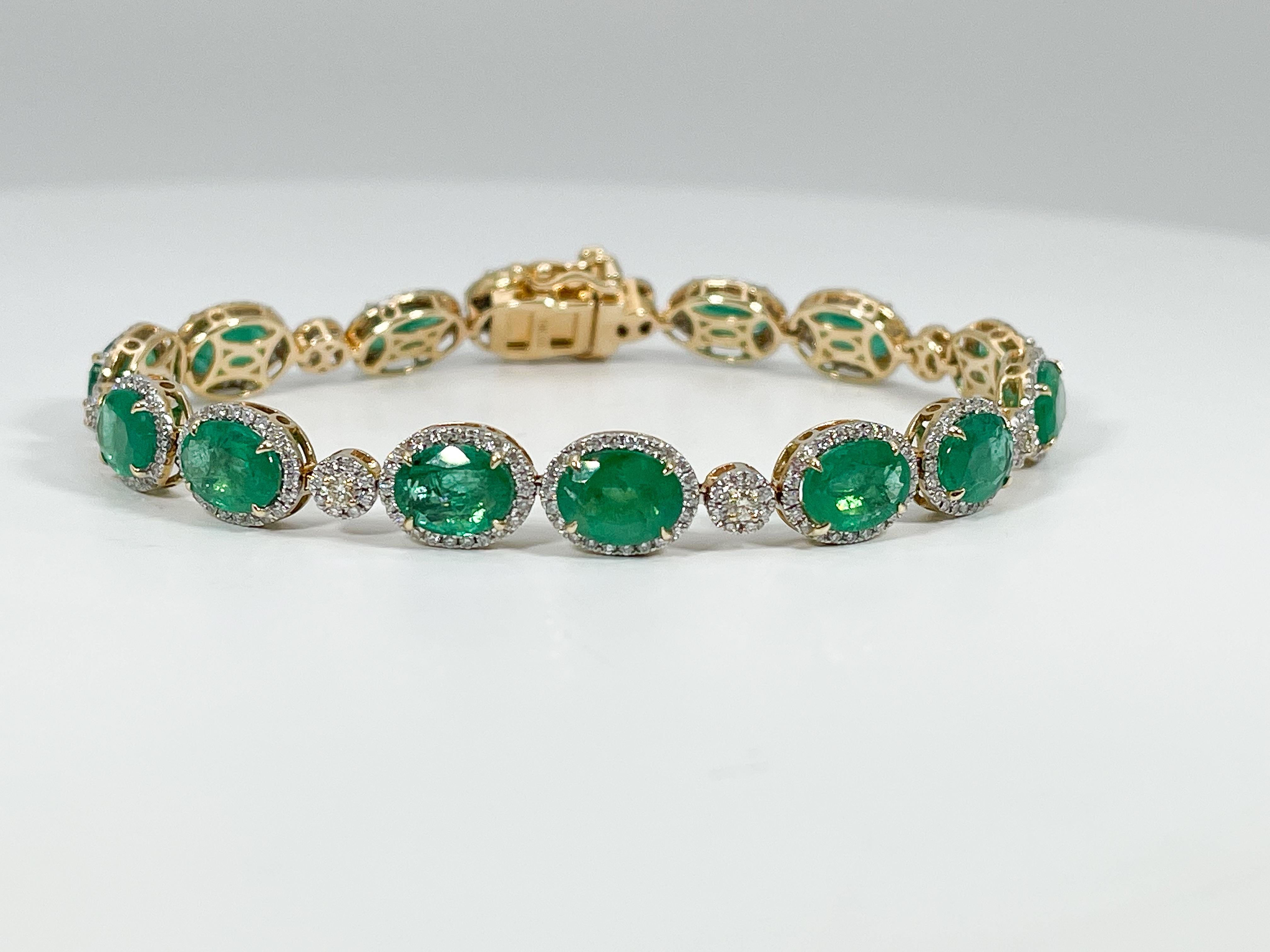 Pulsera femenina de oro blanco y amarillo de 14k engastada con esmeraldas ovaladas talla brillante y diamantes redondos talla brillante amarillo claro y casi incoloros. La pulsera mide 7 1/8 pulgadas de largo por 8 mm de ancho y está acabada con un