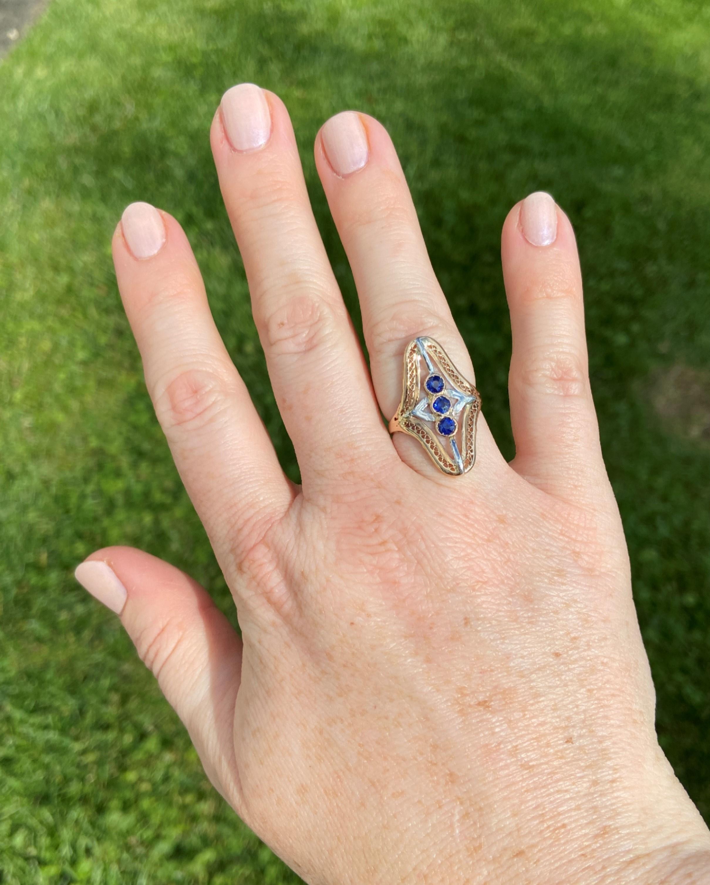 Three deep blue 0.75tcw natural sapphires are the centerpiece of this incredibly detailed ring. The length of the ring is very flattering on the hand, and the slight bowed shape makes it effortlessly comfortable to wear. It is silky smooth and low