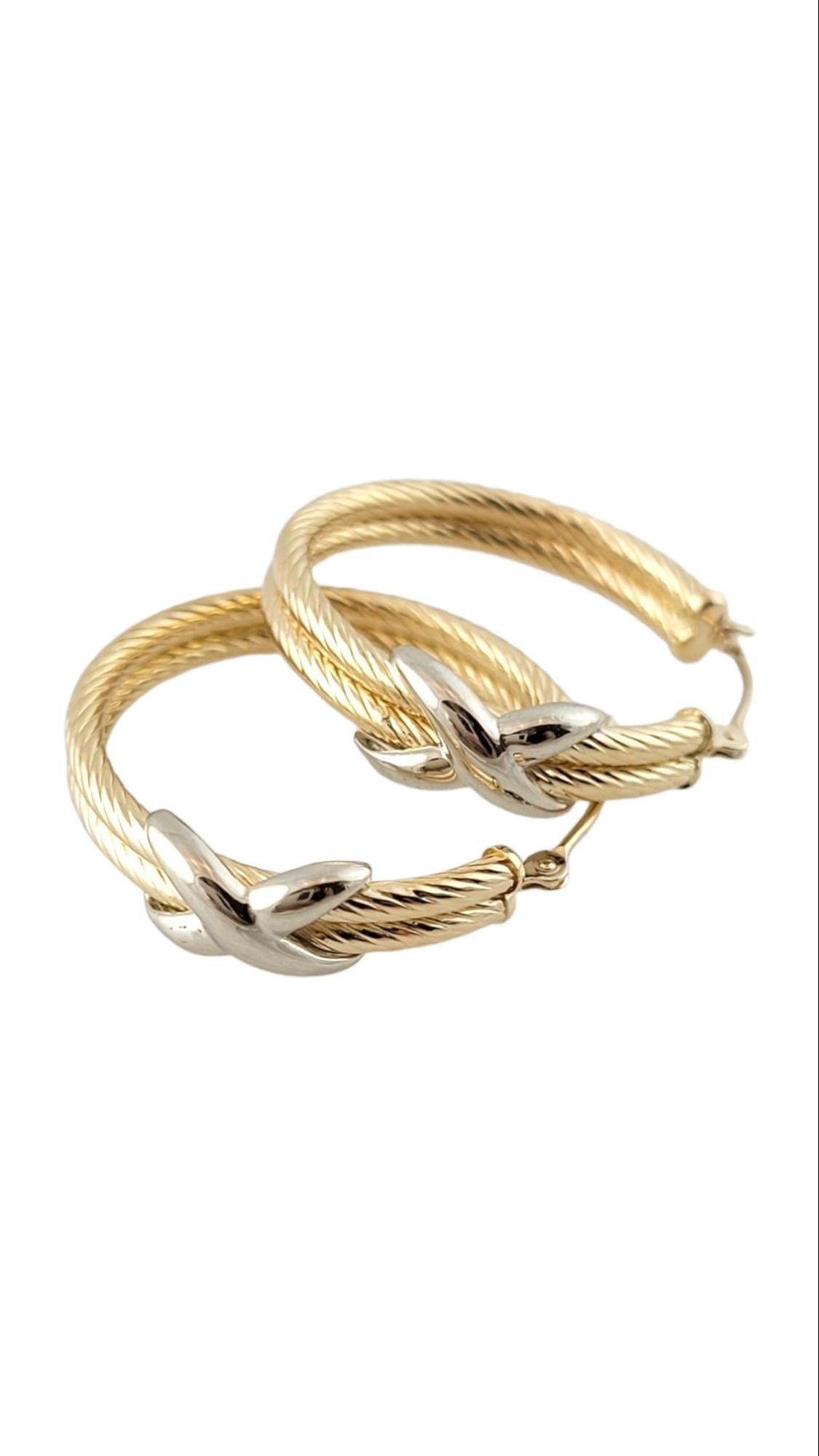 14K Yellow and White Gold Two Tone Twist Double Hoop Earrings

This gorgeous set of 14K yellow gold double twist hoop earrings feature a beautiful 14K white gold X in the front!

Size: 25.0mm X 25.6mm X 6.1mm

Weight: 3.07 g / 2.0 dwt

Hallmark: 14K