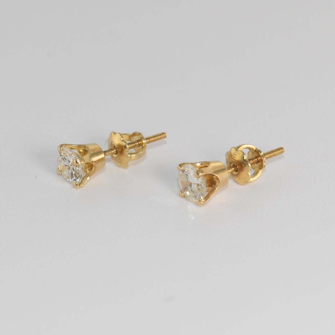 Diamond stud earrings in 14k yellow gold settings.
Stamped 585 and weighs 0.9 grams.
The diamonds are round brilliant cuts, 0.75 total carats, i to j color, i1 clarity.
Posts with screw-backs for pierced ears.
Excellent condition.