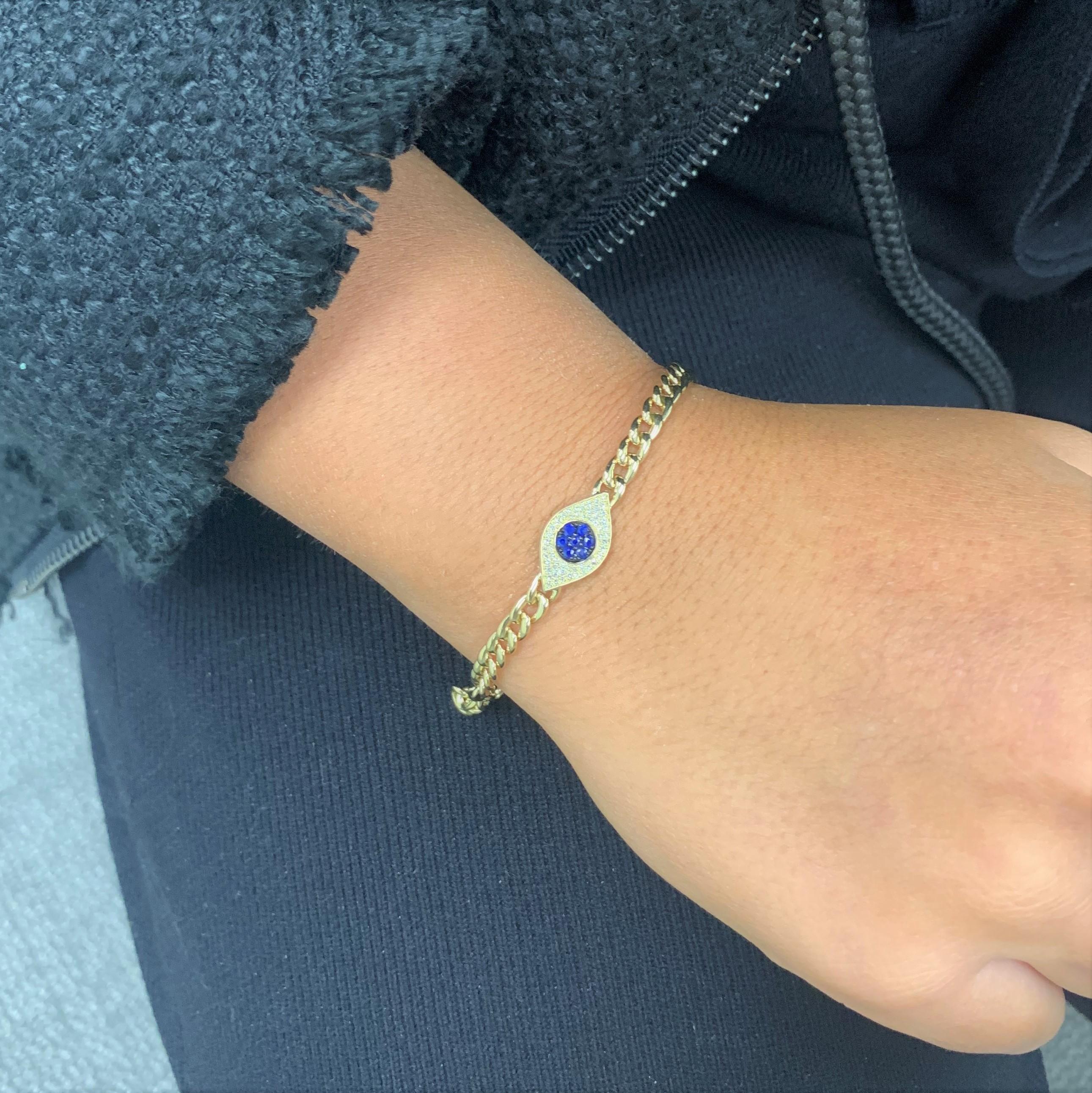 Chic and stylish, the hottest trend in jewelry fashion! Feel protected by this stunning Diamond Evil Eye bracelet featuring approximately 0.12 ct of sparkling white round diamonds and 0.17 ct of stunning blue sapphires.  
-14K Gold
-0.12 ct. Natural