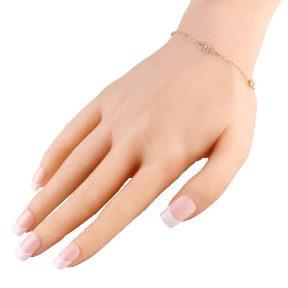 A must-have for everyday wear. This yellow gold wrist accessory features a delicate bracelet chain in 14K yellow gold fastened by a lobster clasp. It shimmers with three stations embellished with high-quality diamonds.This brand new 14K Yellow Gold