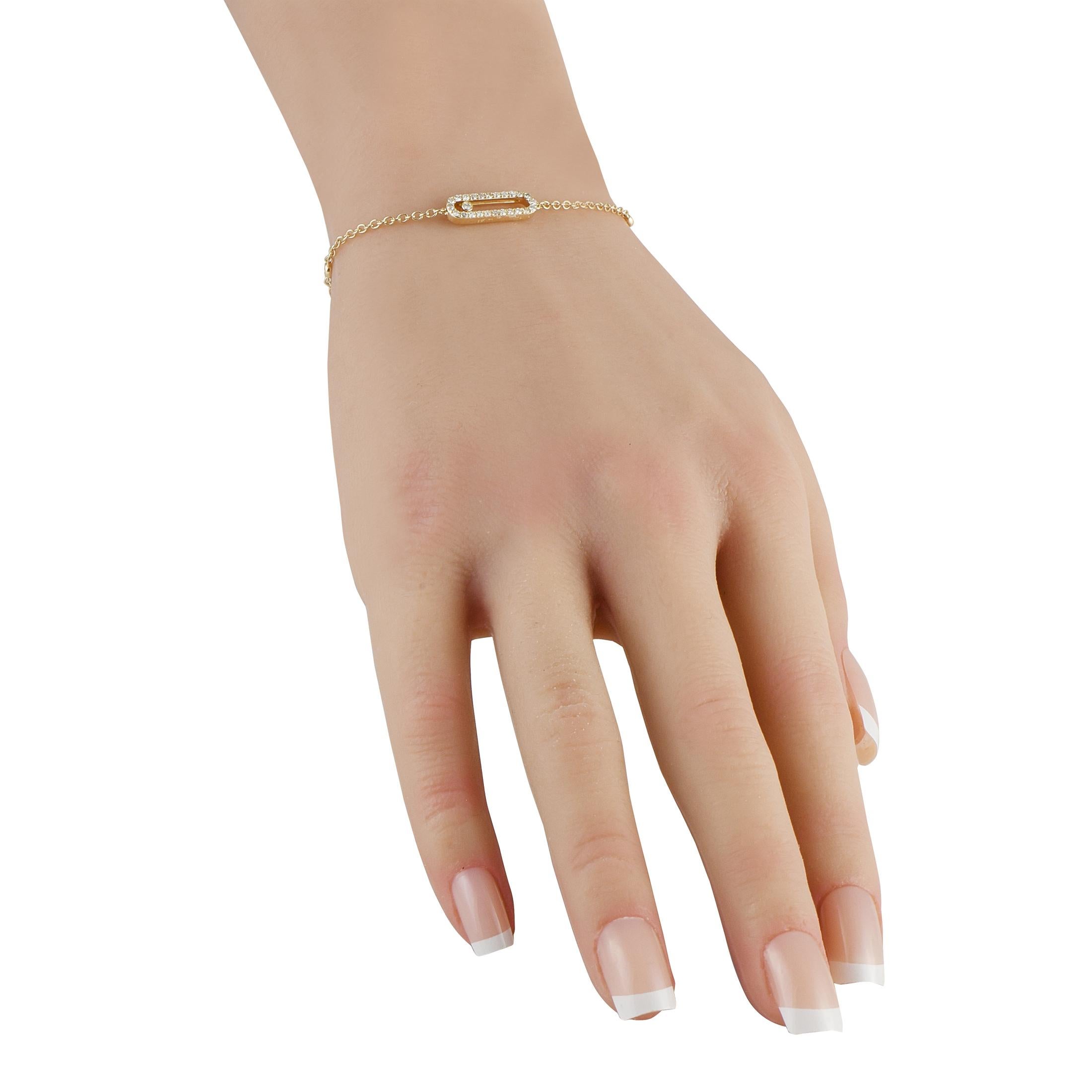 Designed with a fine cable chain in 14K yellow gold, this minimalist bracelet showcases a refined silhouette that's subtle enough for every setting. It is adorned with an elongated oval track that is shaped like a delicate paperclip and traced with