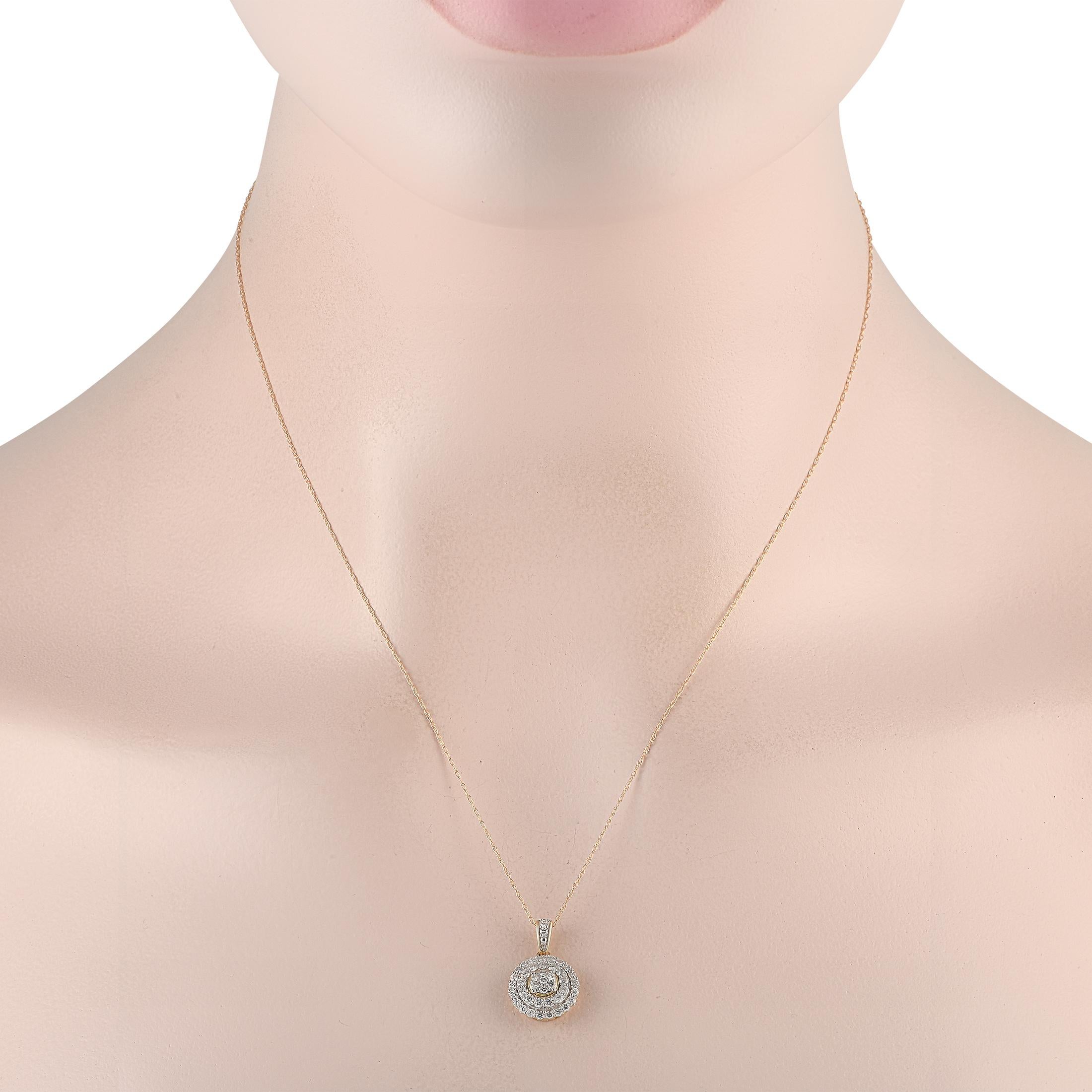 Quickly dress up a casual sweater or a jeans-and-tee outfit with the subtle elegance of this diamond necklace. It has a thin chain with a spring ring clasp, and a disc pendant. The round pendant has its center filled with a cluster of diamonds. Two