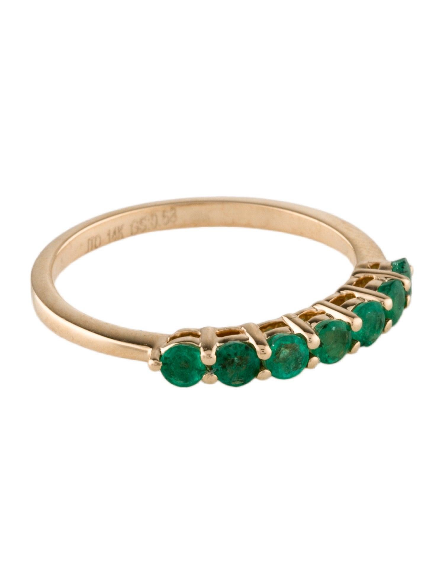 Elevate your jewelry collection with the timeless elegance of our 14K Yellow Gold Emerald Band. This exquisite piece, sized 8, is adorned with seven Round Modified Brilliant Emeralds totaling 0.55 carats. Each emerald, chosen for its vibrant green